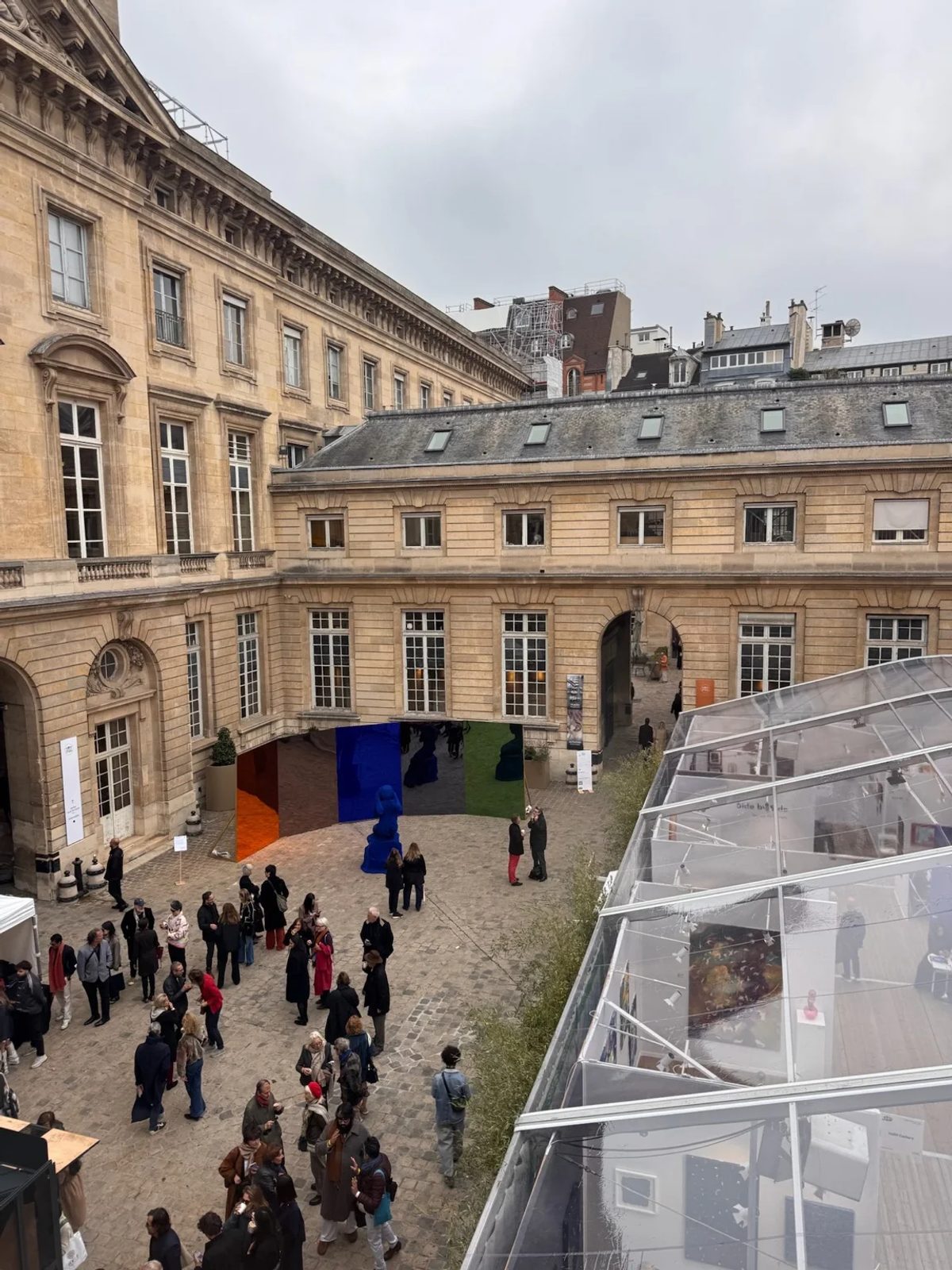 Visitors and exhibition pavilions at Asia NOW 2026 in the courtyard of the Monnaie de Paris.