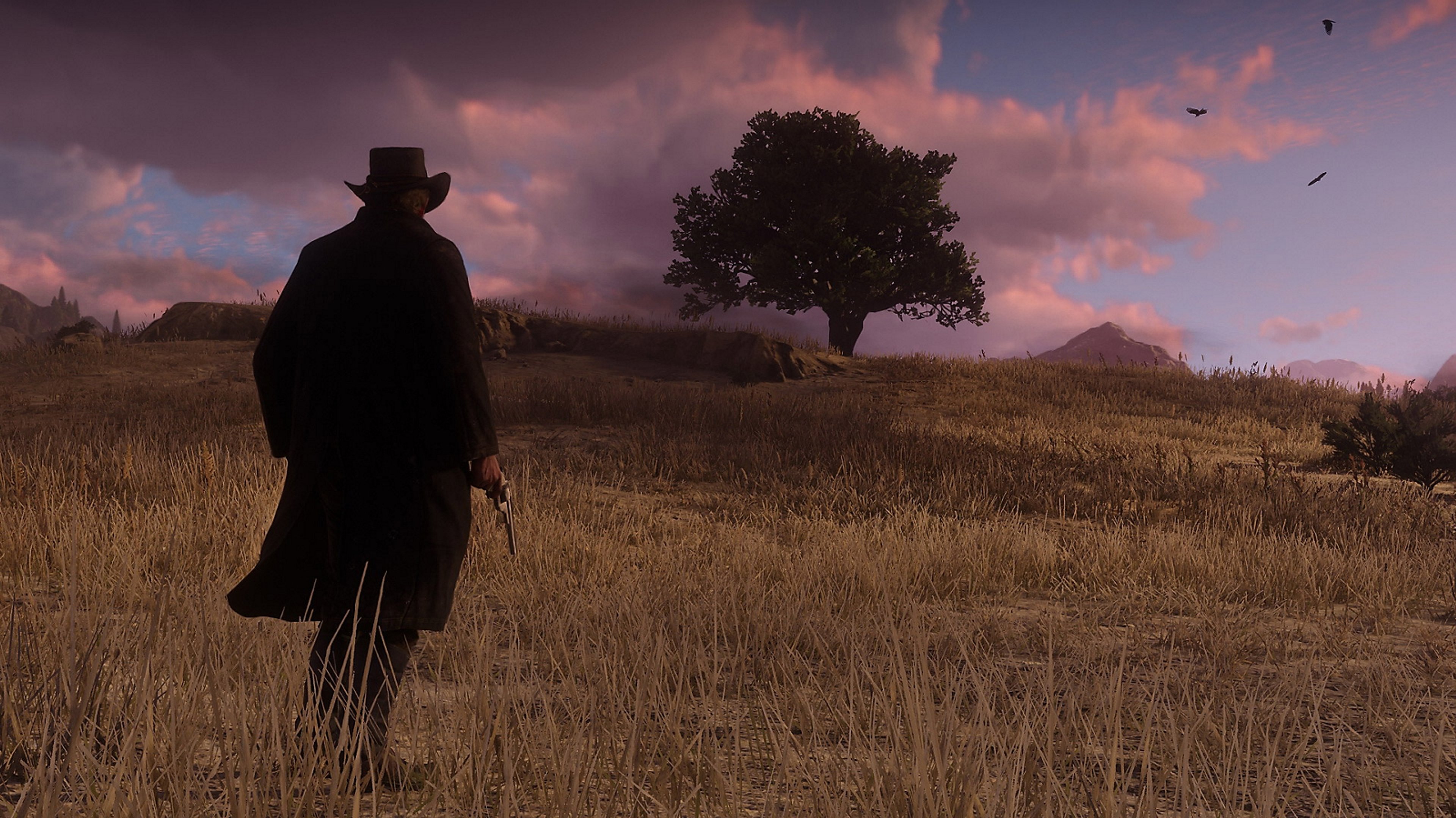 Arthur Morgan riding alone across open country at sunset.