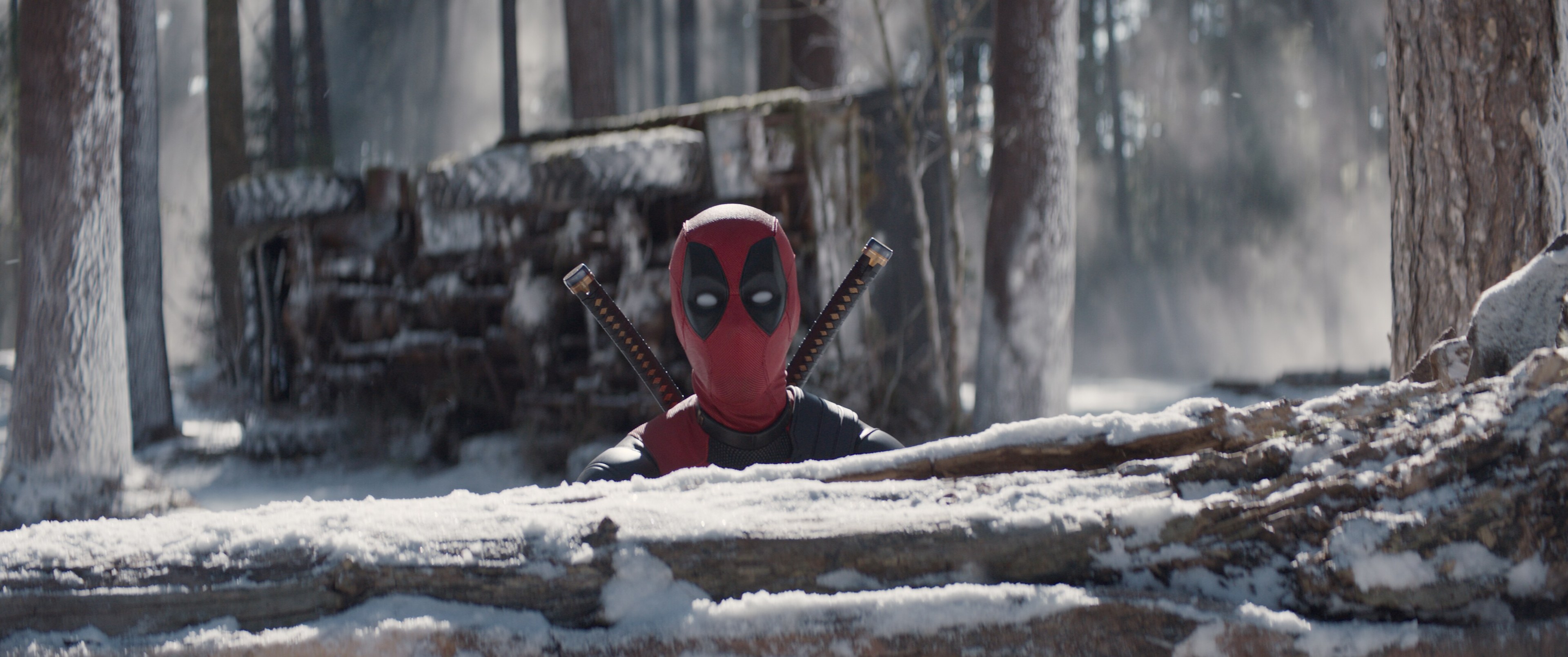 Deadpool walks through a snowy forest in Deadpool & Wolverine.
