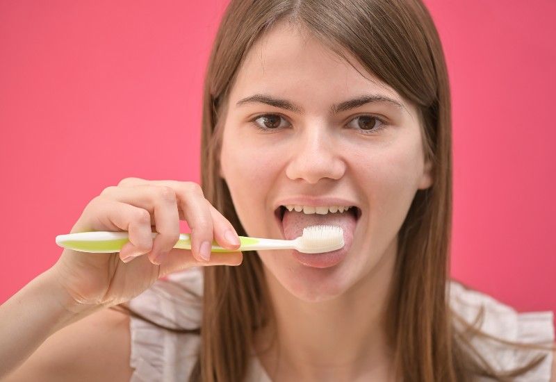 PUSS: Du bør pusse både tennene og tunga etter frokost for å unngå dårlig ånde og for å holde tennene friske. Foto: Colourbox  