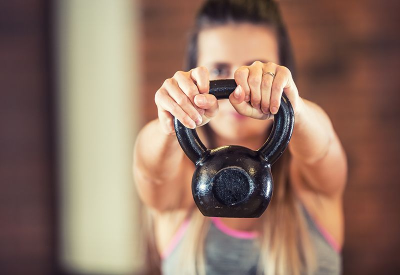Jente løfter kettlebell (www.colourbox.com)
