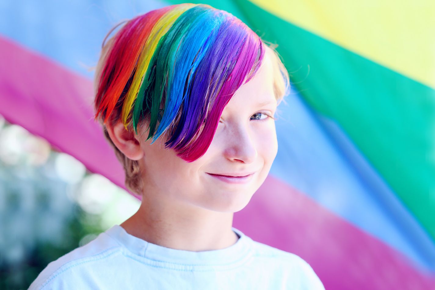 Ung person med regnbuefarget hår.