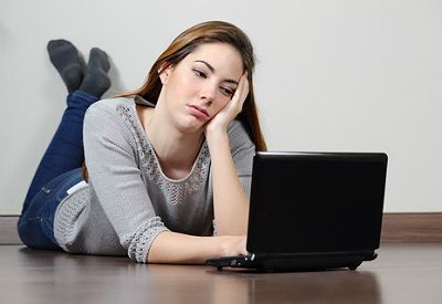Jente foran PC kjeder seg. (www.colourbox.com)