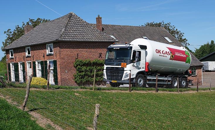 Tank truck from OK GAS supplying a home with propane gas