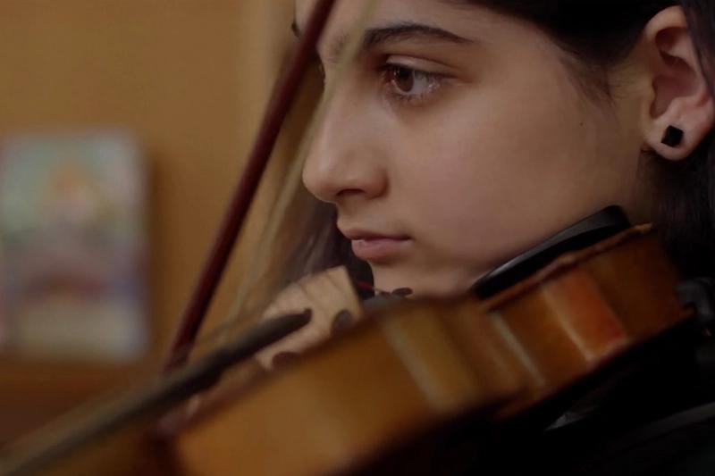 Pathways graduate Zara playing her instrument