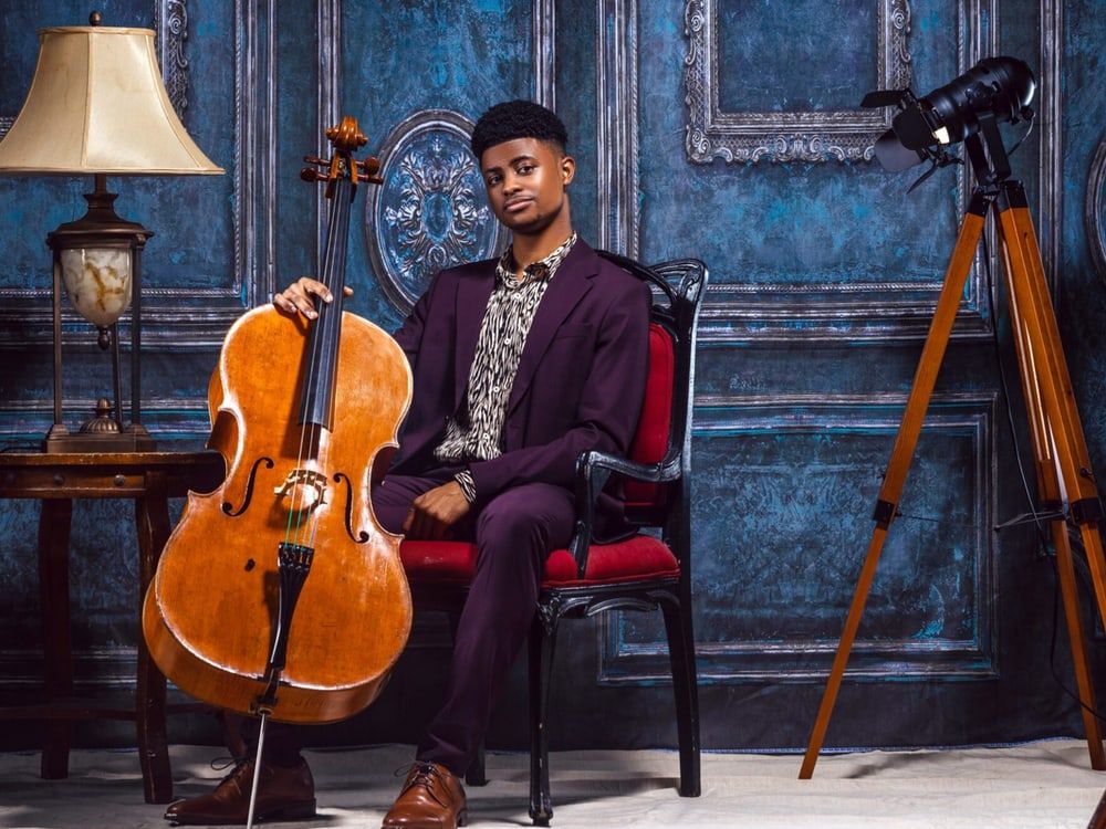 Sterling Elliott seated with his cello