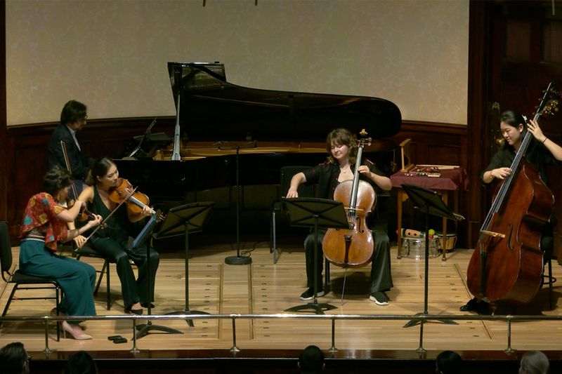 Kaleidoscope Chamber Collective performing on a concert platform with piano, strings and double bass.