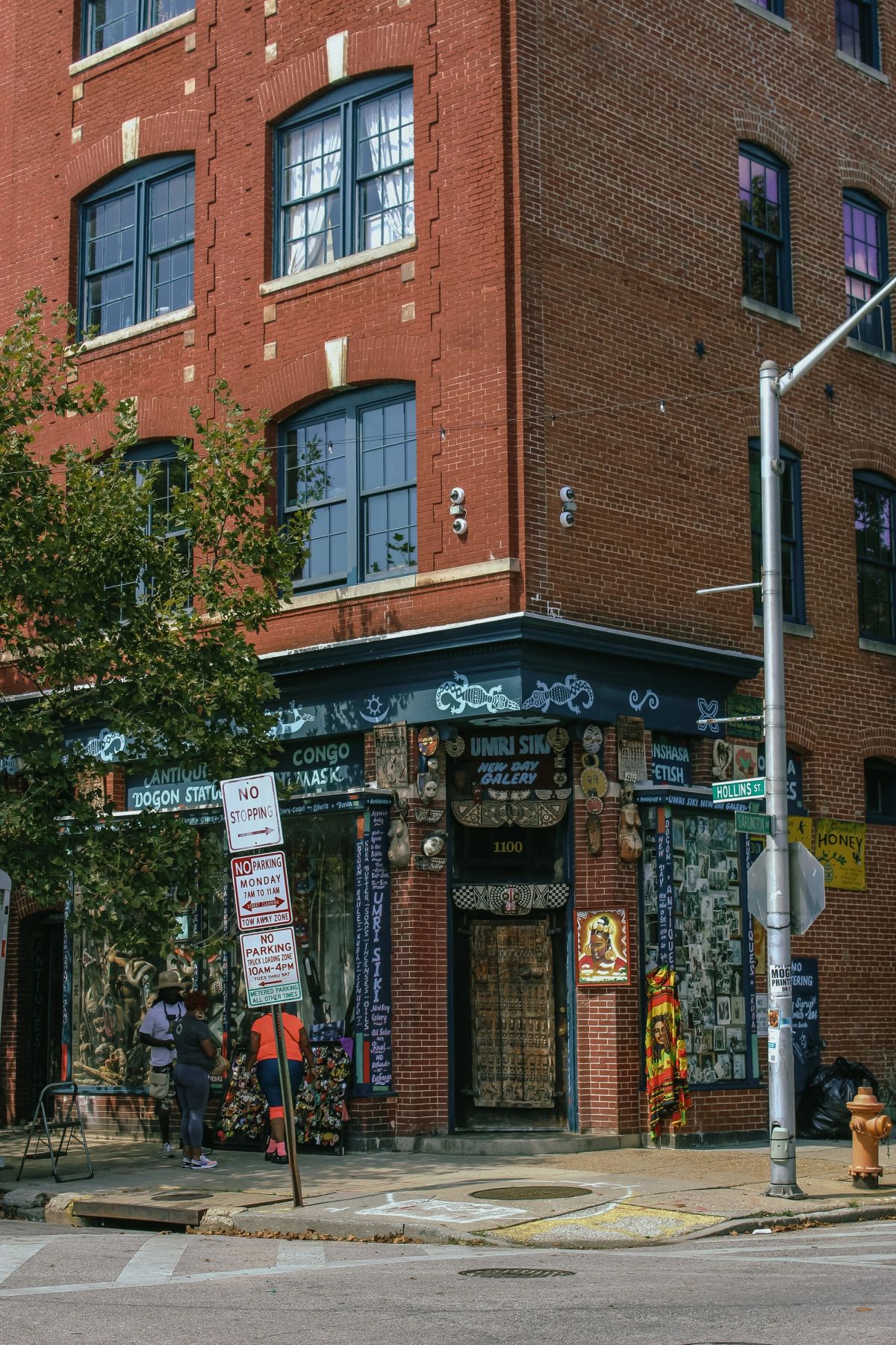 wide editorial photograph of a maryland small business storefront on a historic main street, warm af