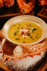 Rustic crab soup bowl garnished with herbs