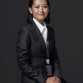 Grace Liu, reviewer — professional headshot of a smiling Asian woman in formal business attire.