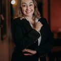 Dana Whitfield, reviewer — professional headshot of a smiling woman in a formal suit.