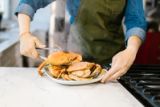 Freshly steamed crabs being served on a kitchen counter