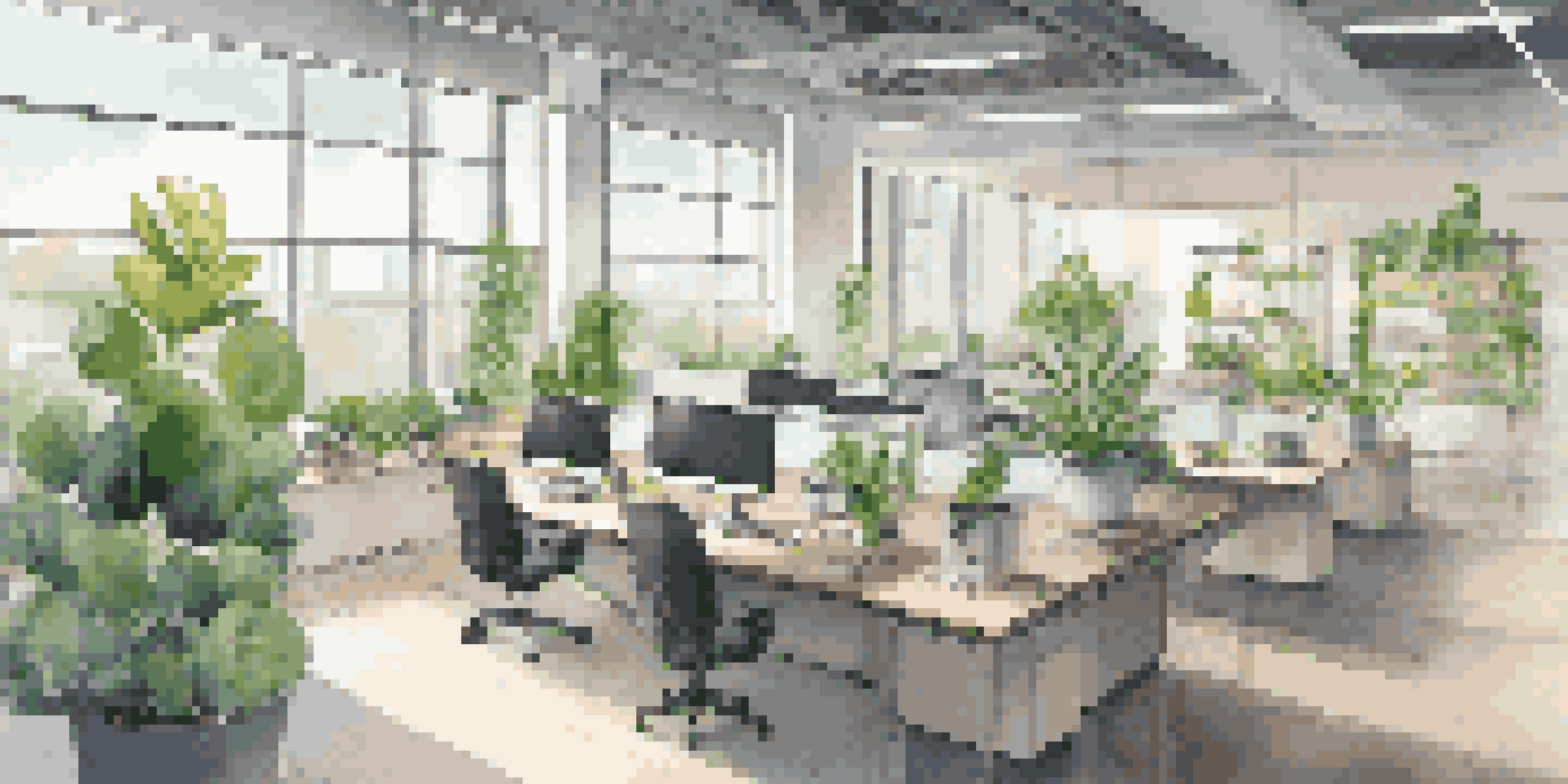 A bright and modern office space showcasing sustainable design with plants, LED lights, and smart technology.