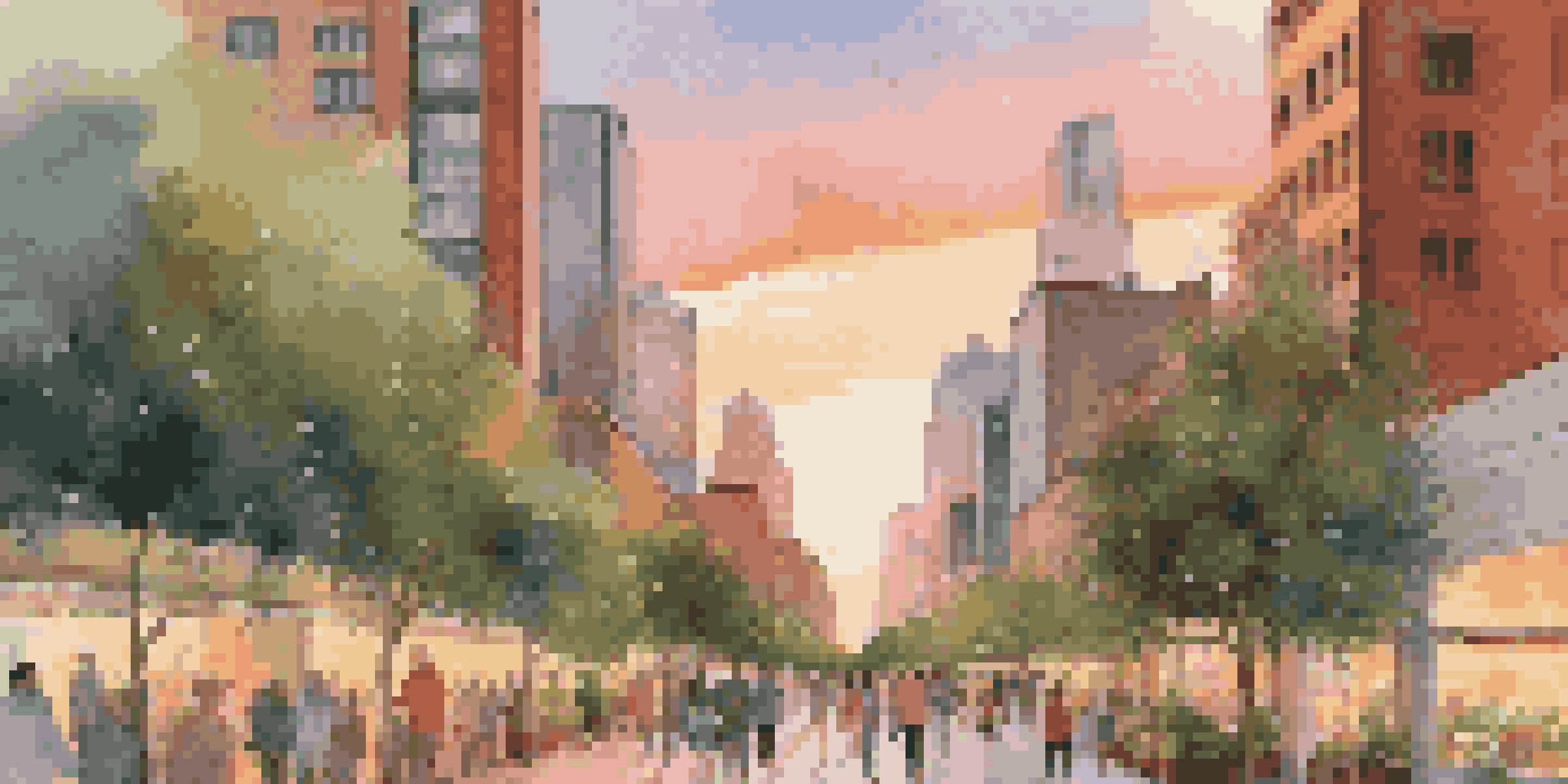 A city skyline at dusk with skyscrapers covered in greenery and a warm sunset sky.