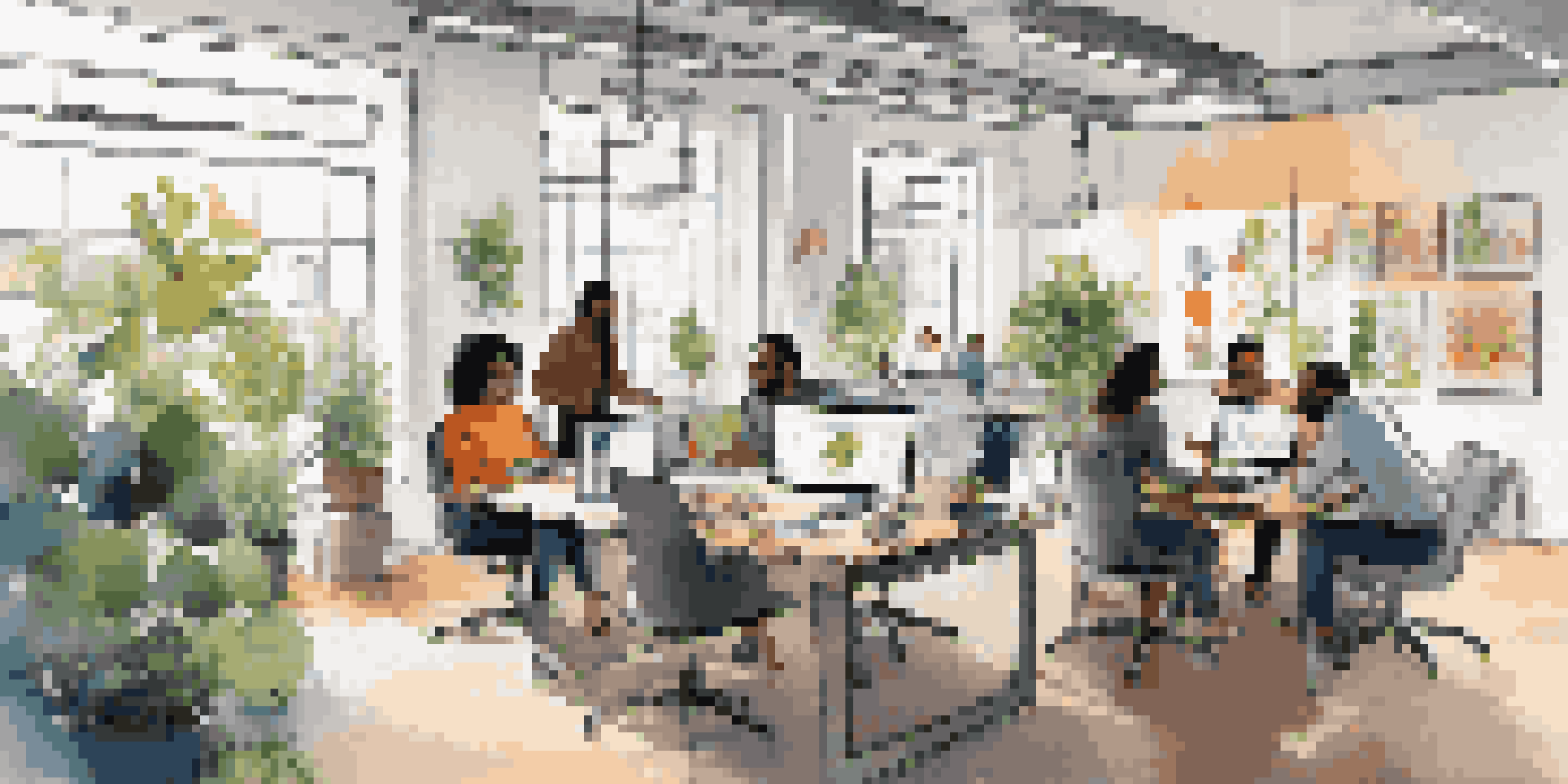 A diverse team of professionals collaborating in a bright modern office, with sketches and laptops on a table.
