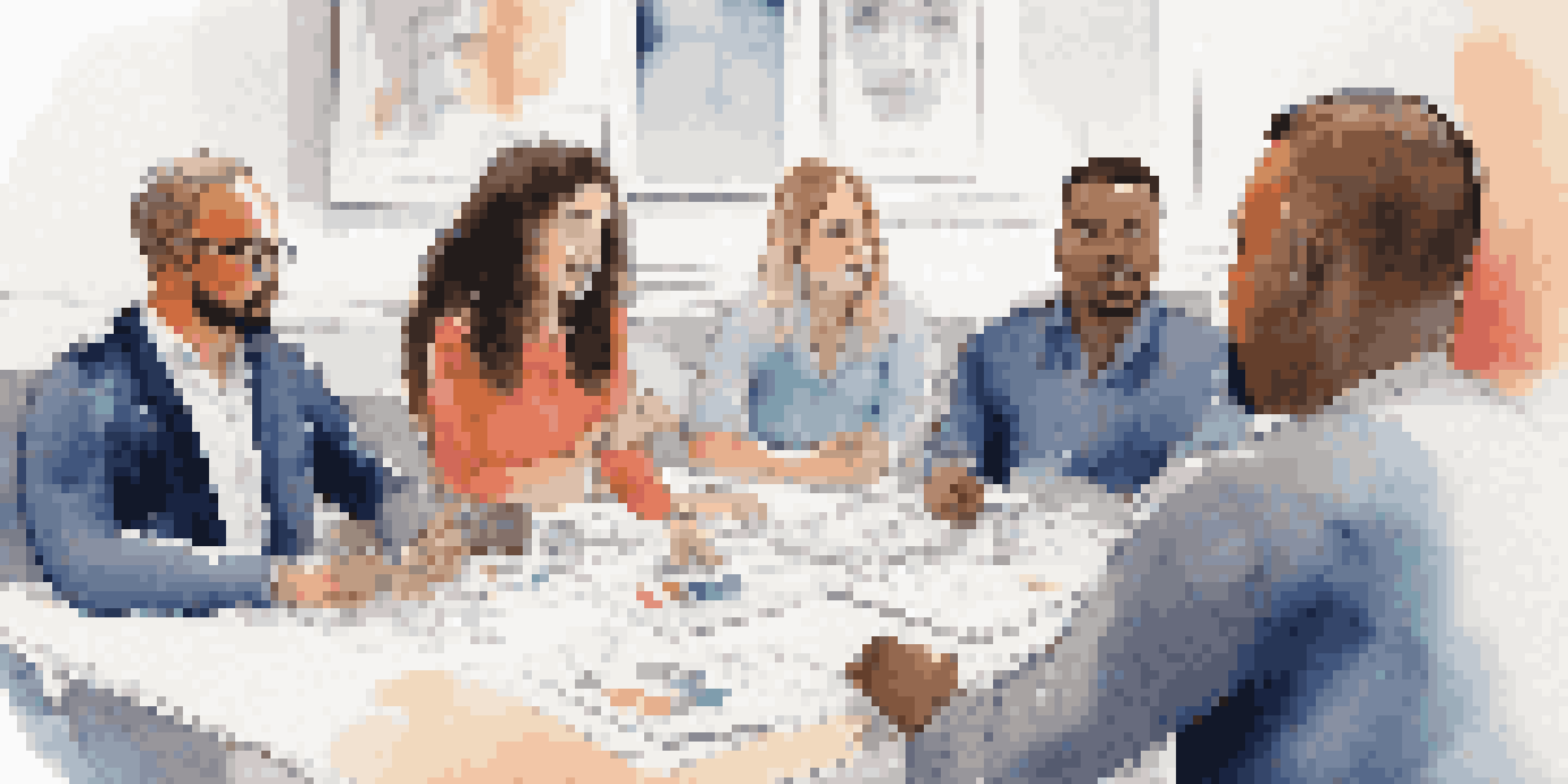 A close-up of a team leader listening to diverse team members sharing ideas in a modern meeting room.