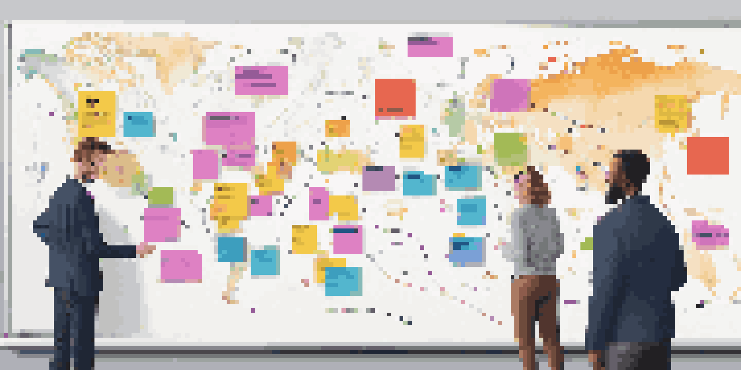A team collaborating around a whiteboard filled with a colorful customer journey map, showcasing various touchpoints and personas.