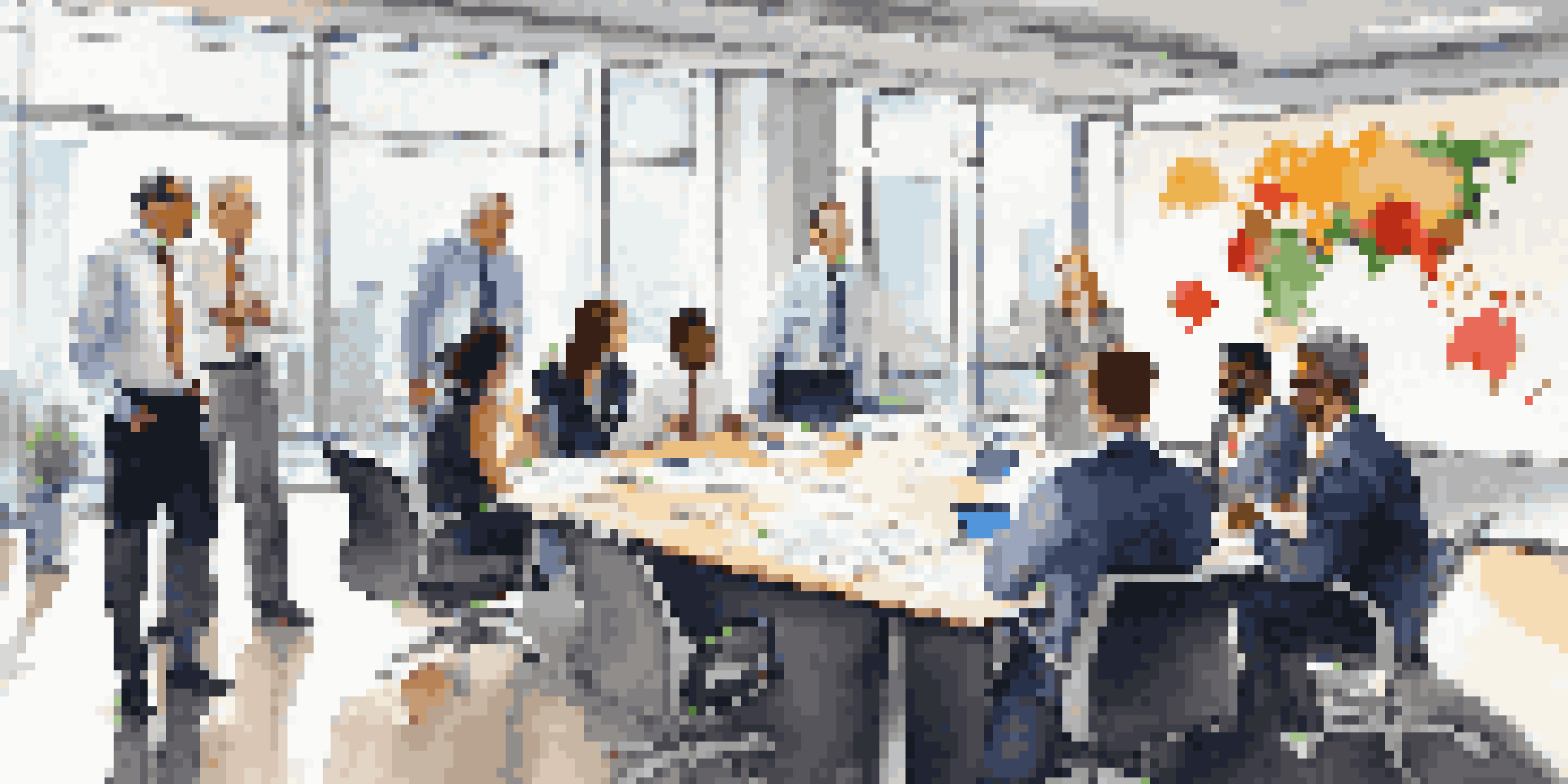 A diverse group of business professionals having a meeting in a well-lit conference room with charts on the whiteboard.