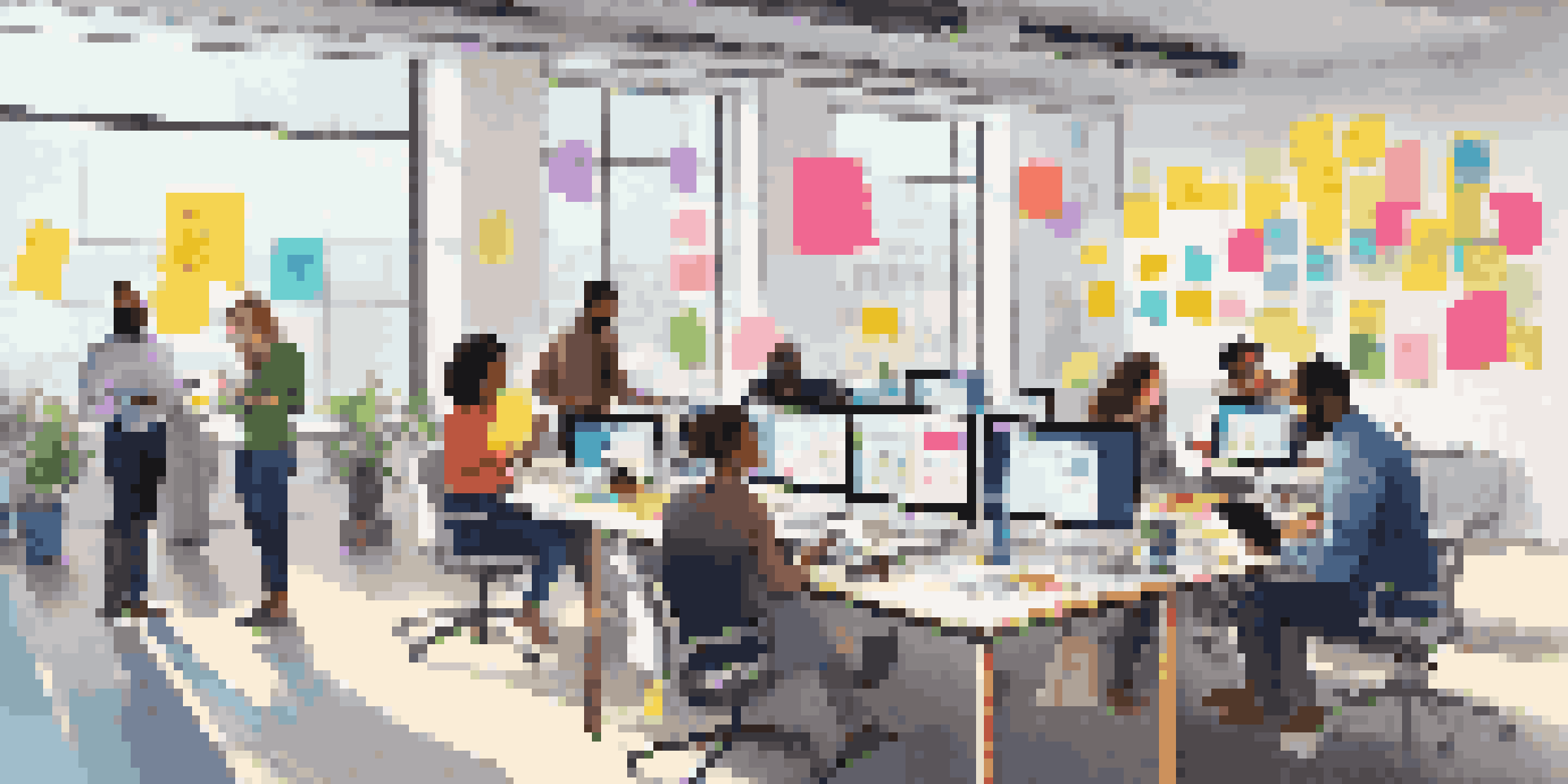 A group of diverse employees collaborating in a bright office, surrounded by colorful sticky notes and digital devices.