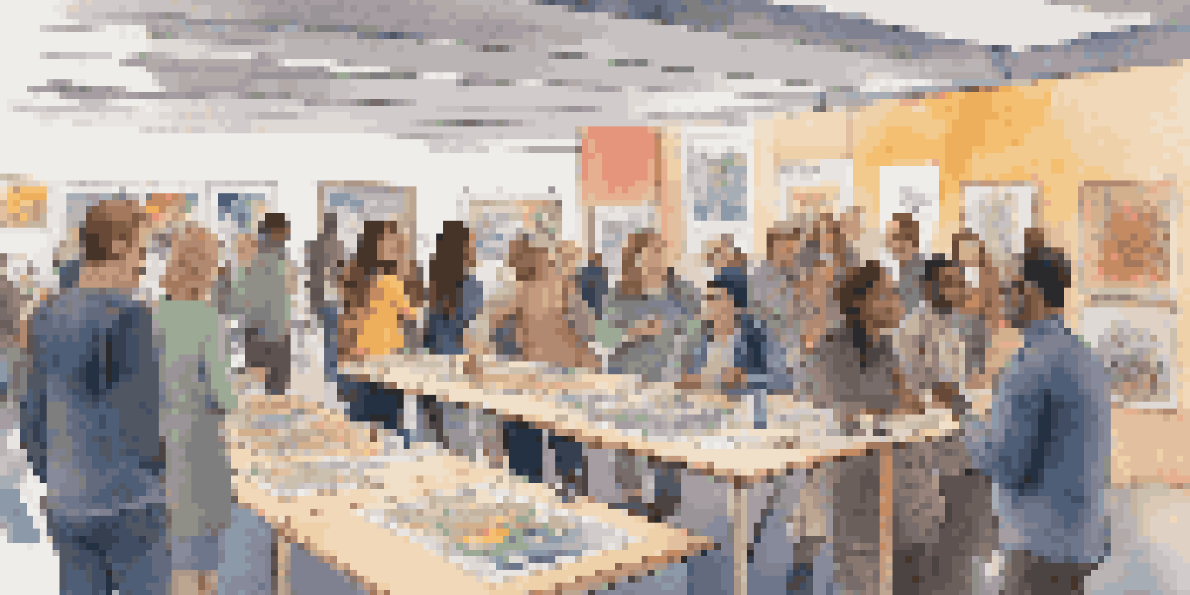 A vibrant crowdfunding event with diverse attendees discussing creative projects, surrounded by colorful displays and warm lighting.