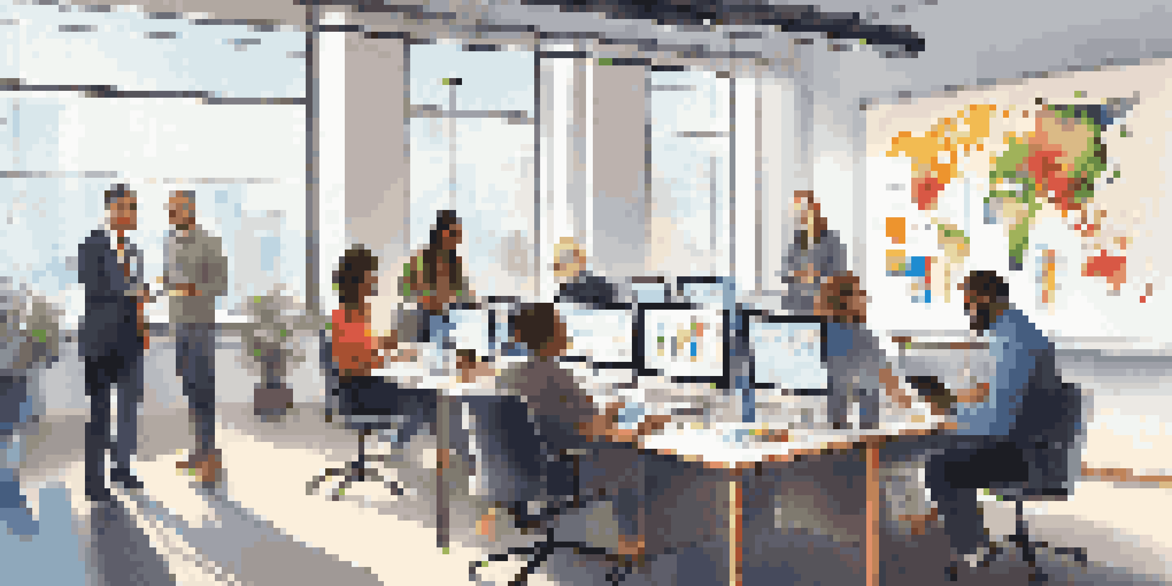 A diverse team of professionals in a bright office analyzing customer feedback together around a table.