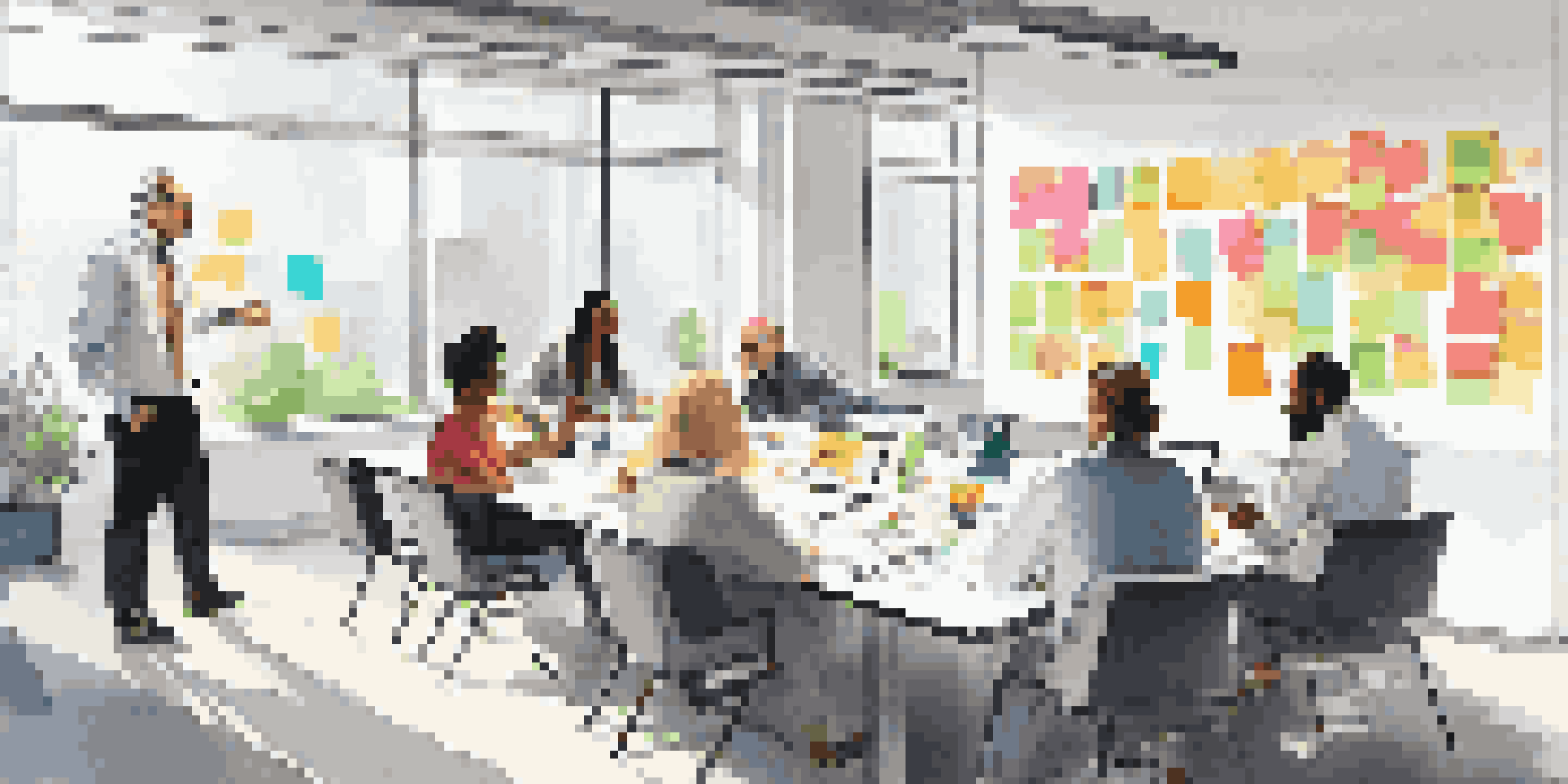 A diverse team in a modern office engaged in a scenario planning workshop, surrounded by whiteboards and sticky notes.