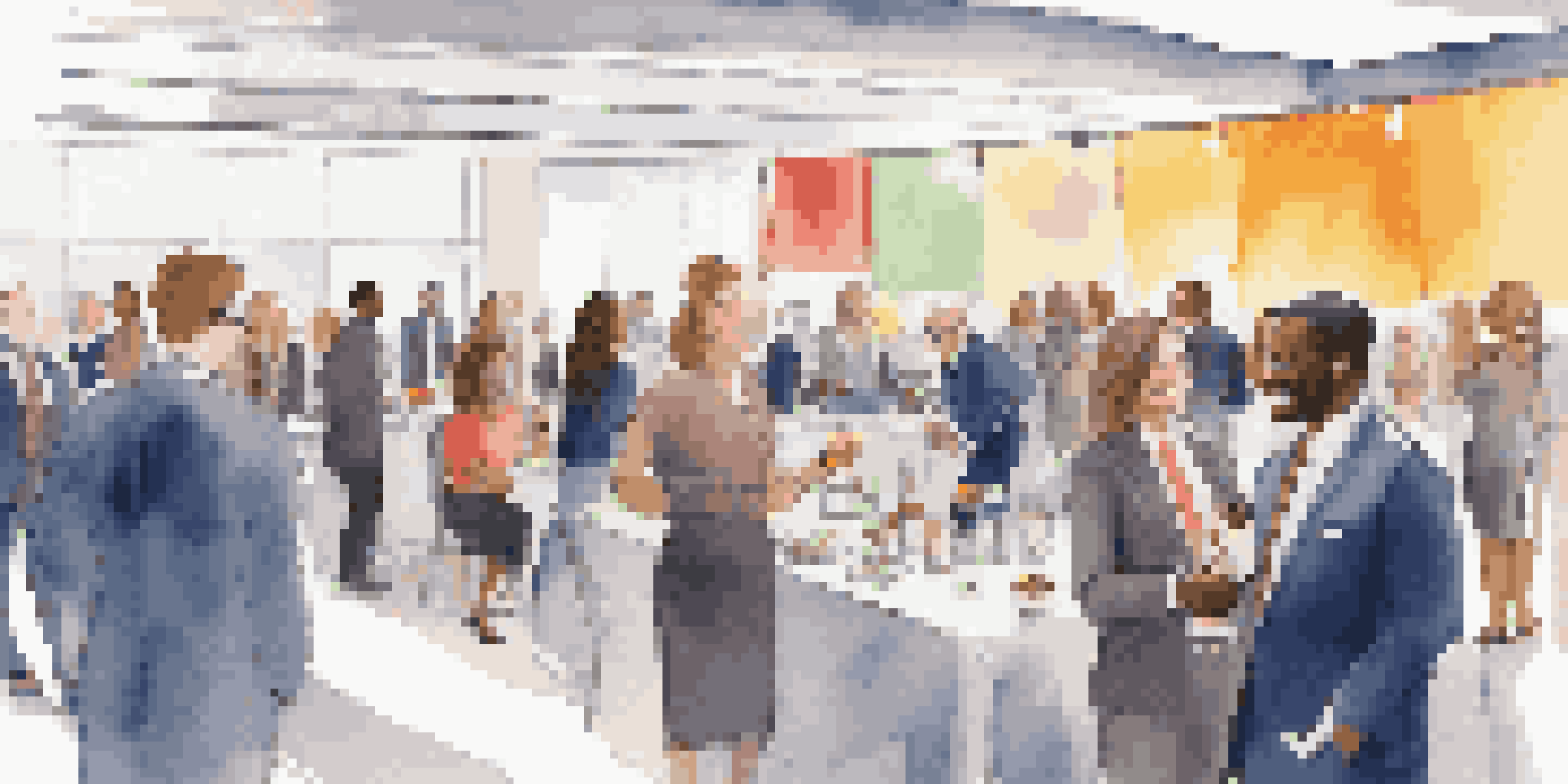 A vibrant conference hall filled with diverse professionals networking and exchanging business cards.
