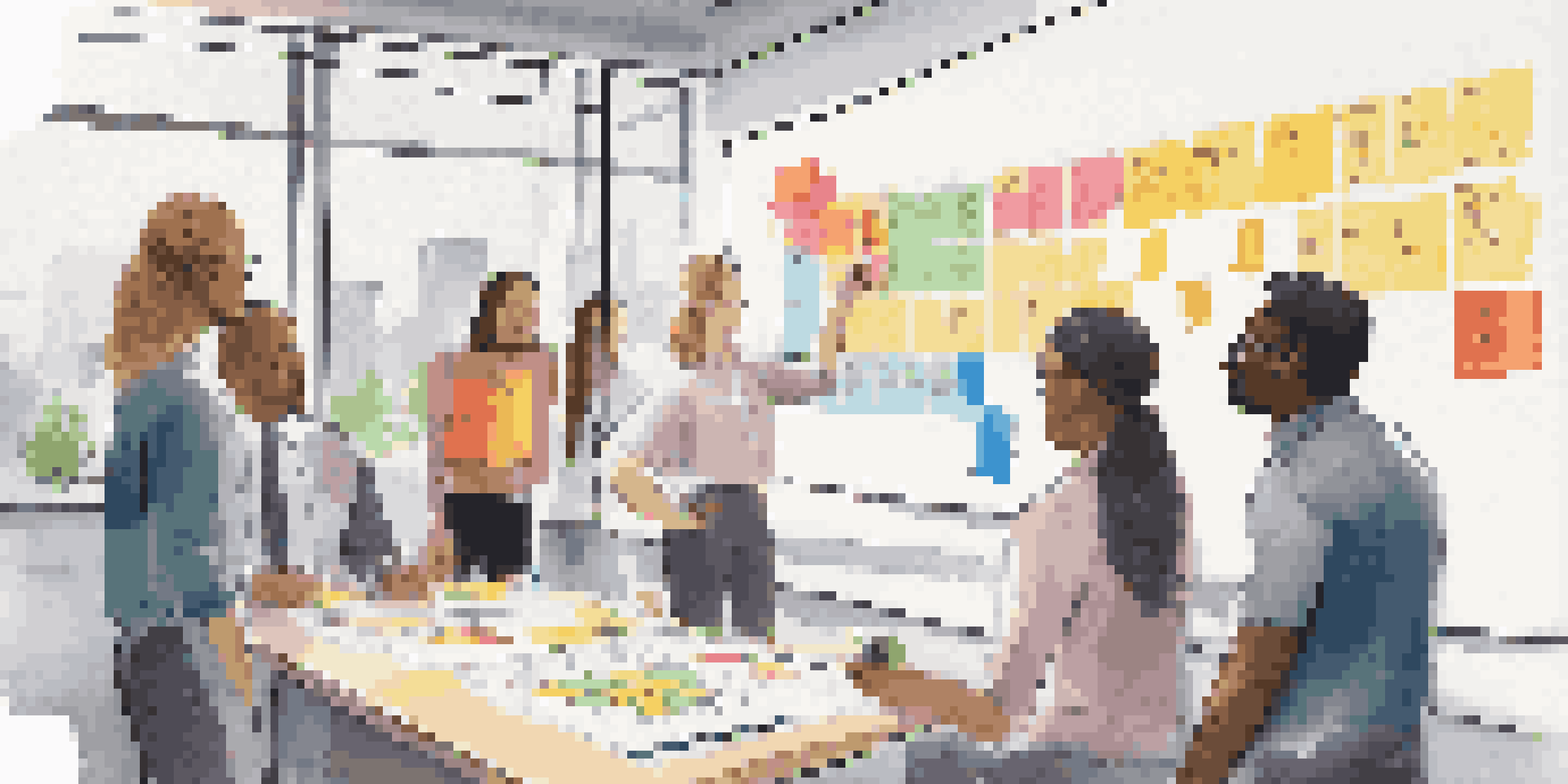 A diverse group of people gathered around a whiteboard covered in colorful sticky notes and a Business Model Canvas, engaged in brainstorming.
