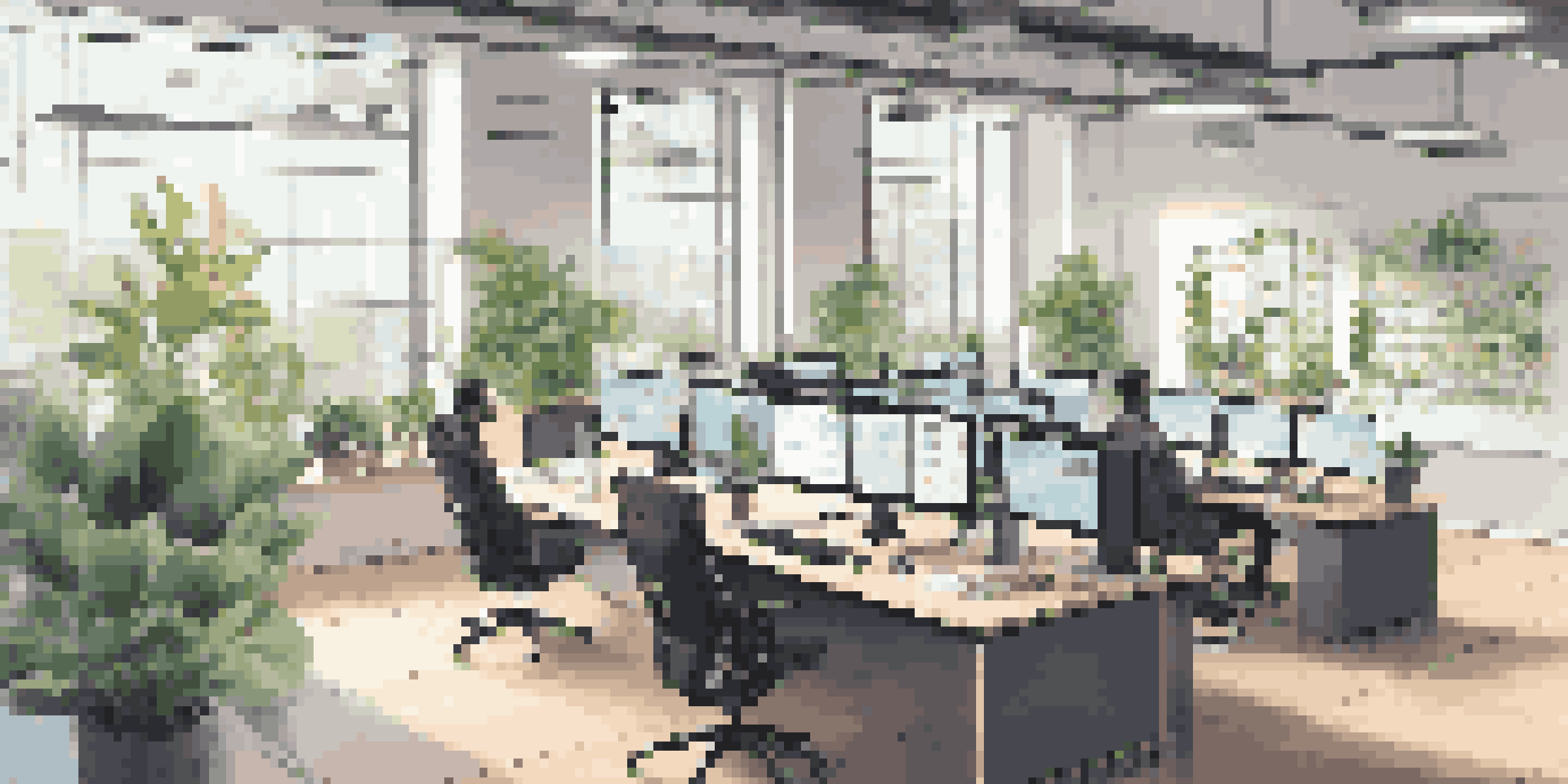 A bright e-commerce workspace with multiple computer monitors showing AI analytics and graphs, decorated with plants and motivational quotes.