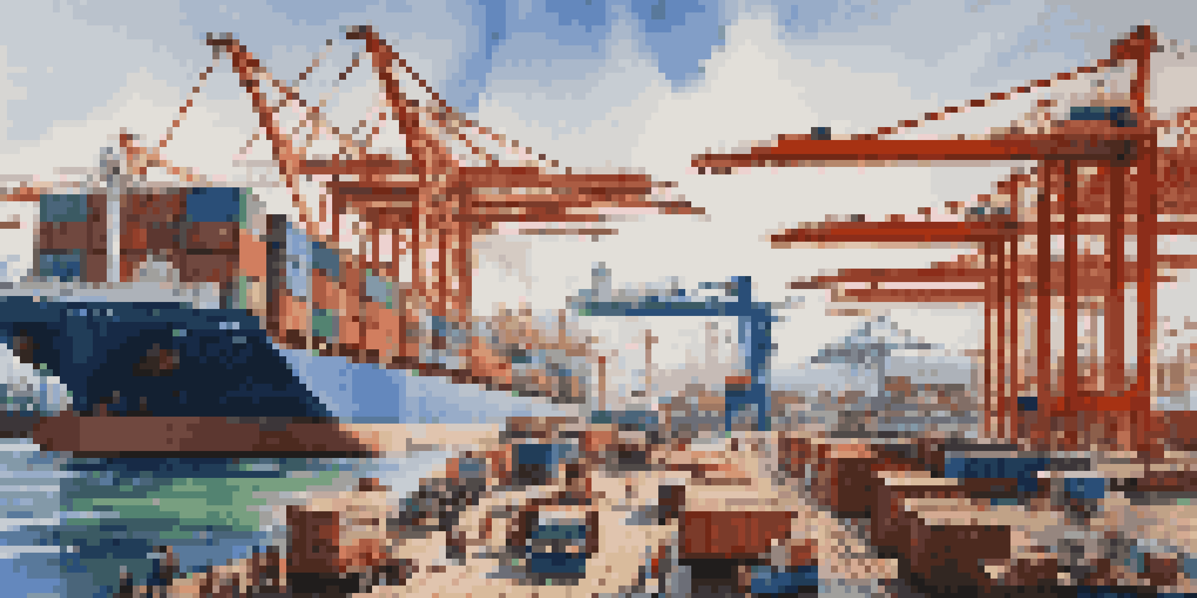 A busy international trade port filled with cargo ships, colorful shipping containers, cranes, and workers under a clear blue sky.