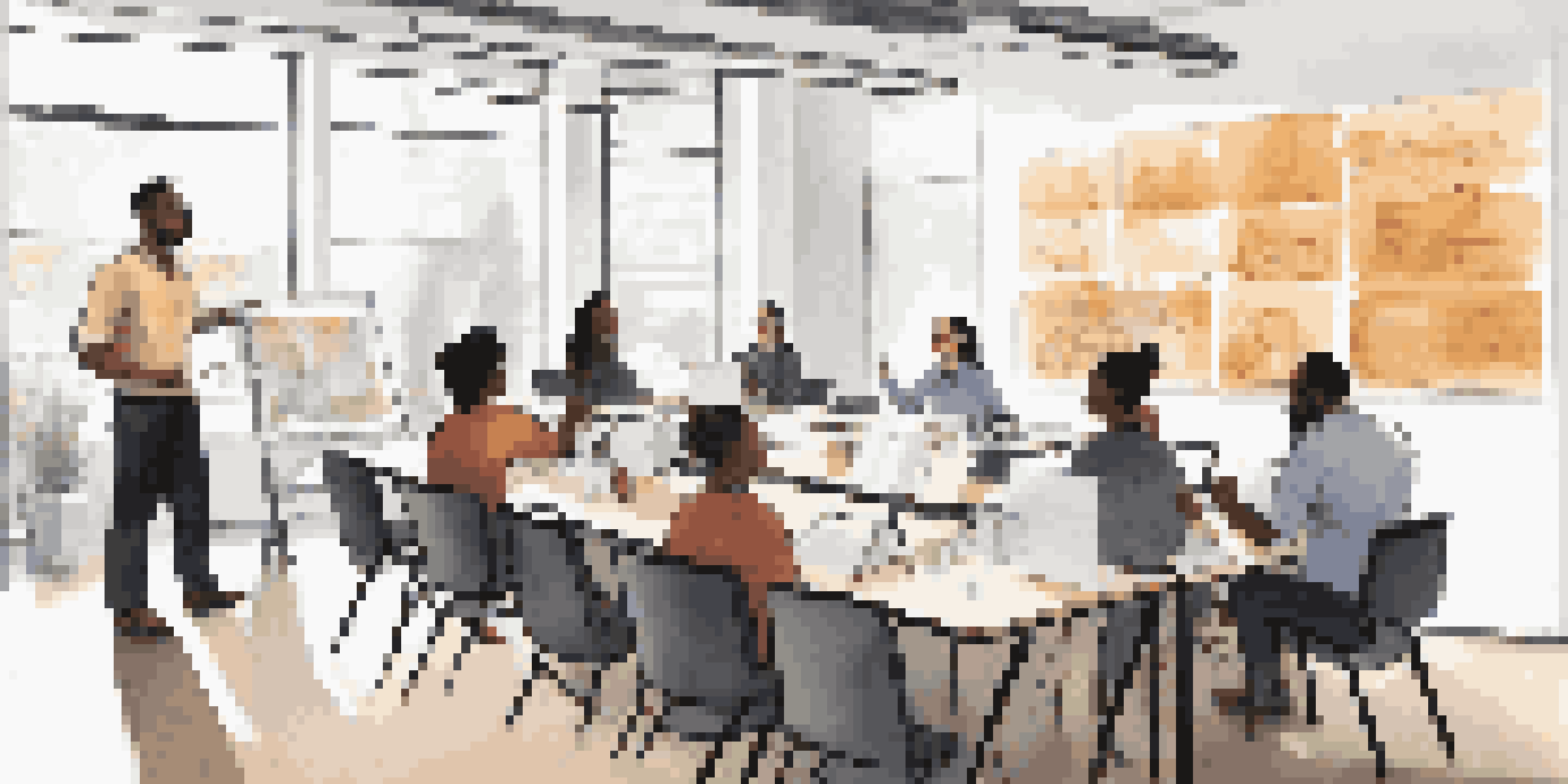 A diverse group of employees engaged in a training session on customer experience, with a facilitator presenting in a well-lit room.