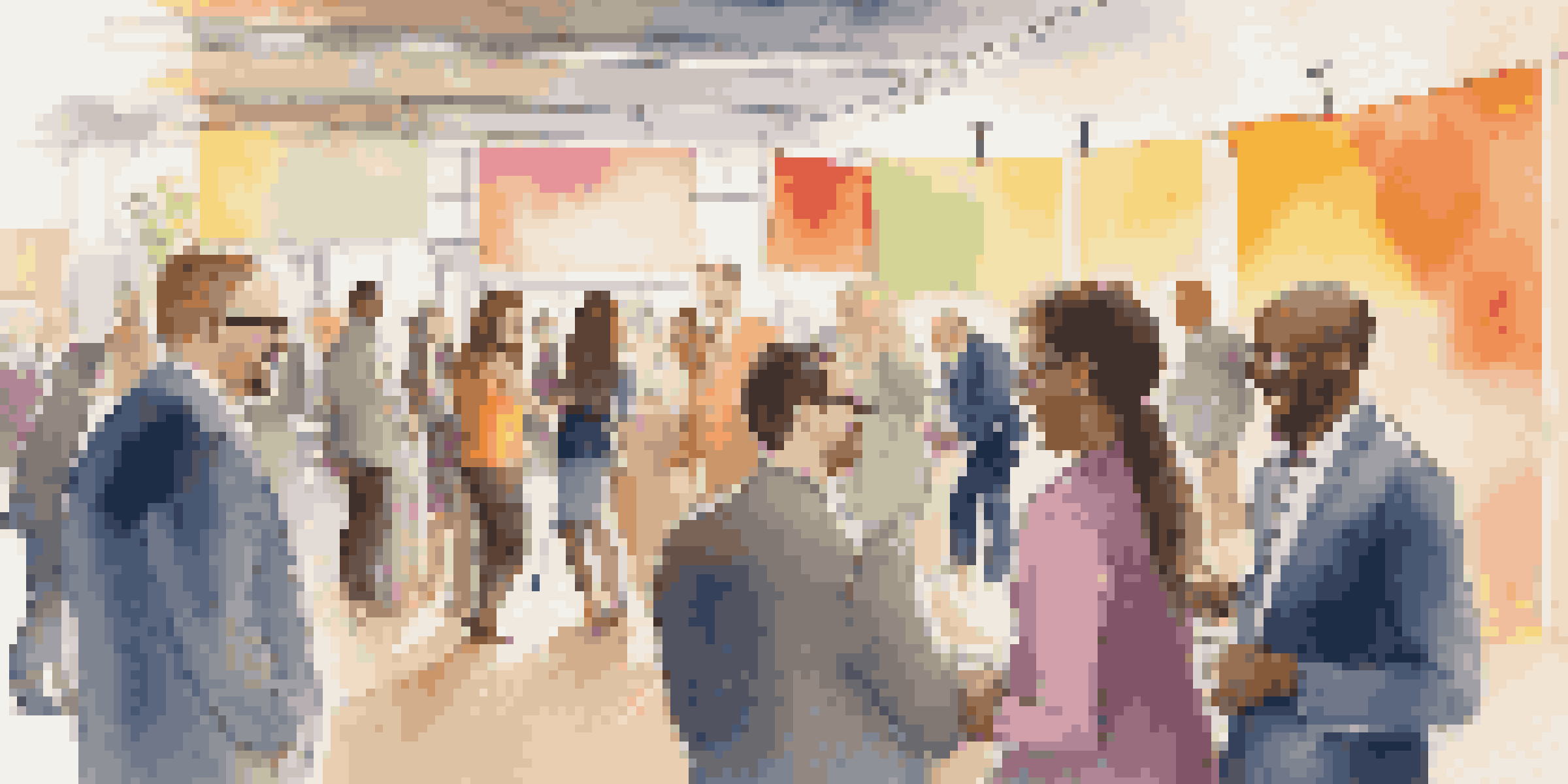 A diverse group of professionals conversing at a networking event, surrounded by colorful banners and soft lighting.