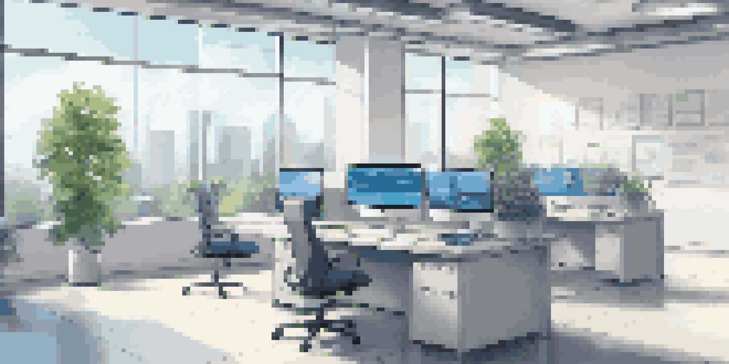 A modern franchise office with a desk, computer, and digital displays. Bright natural light fills the room, showing a professional and organized workspace.