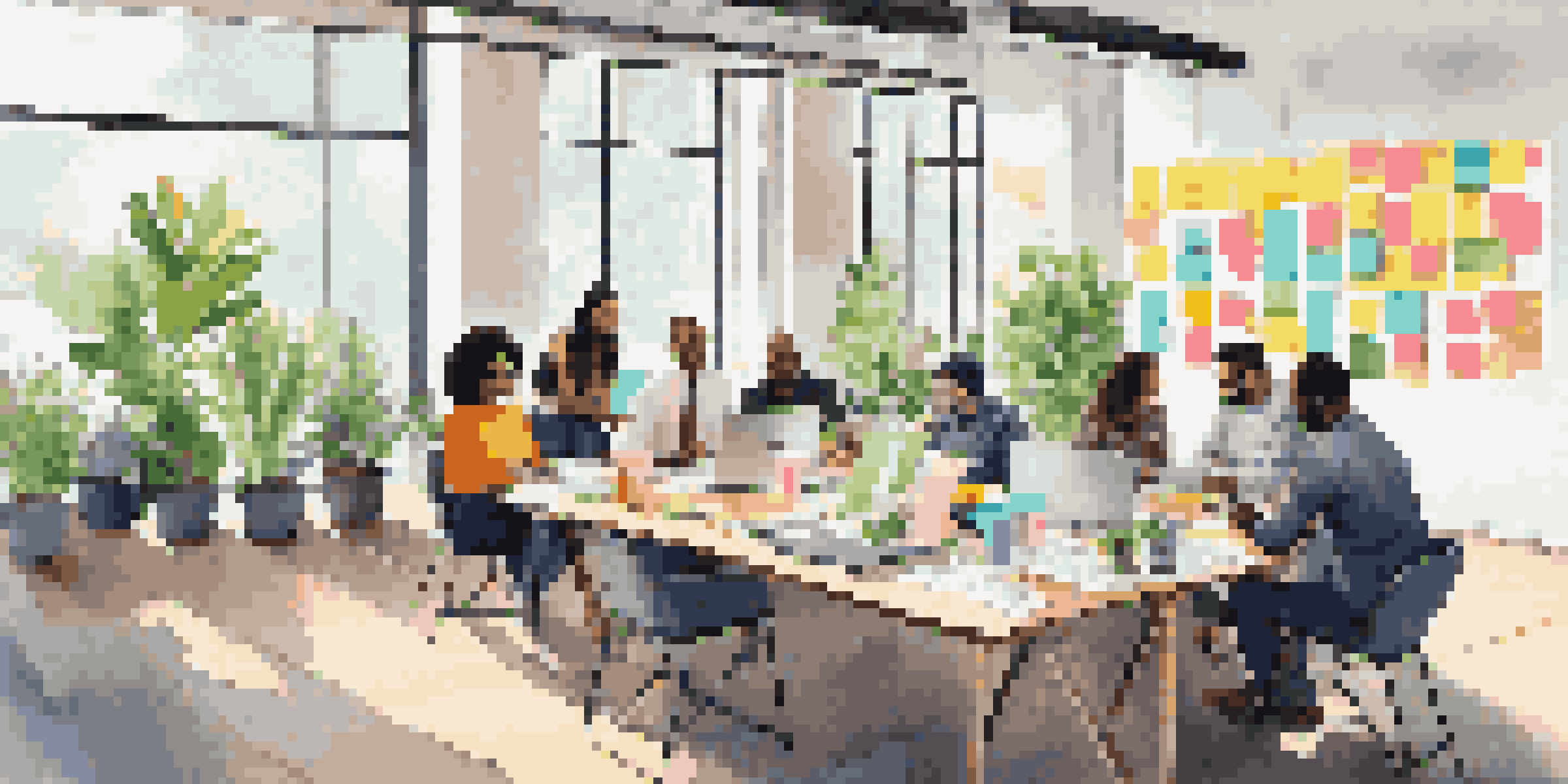 A diverse group of professionals collaborating in a bright and open meeting room, surrounded by colorful sticky notes and laptops.