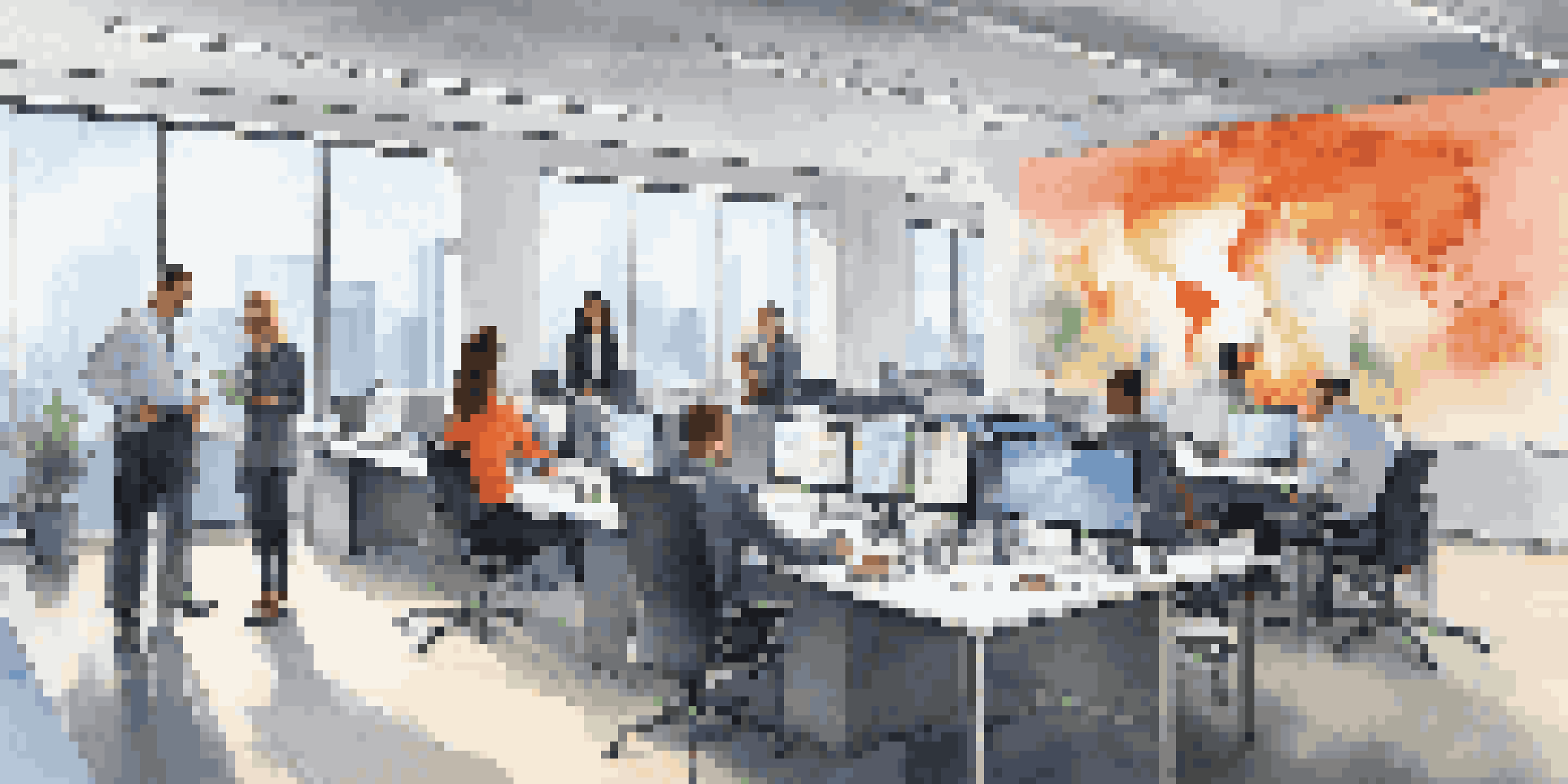 A diverse team of professionals working together in a modern office space, featuring laptops and cloud computing graphics, illuminated by natural light.
