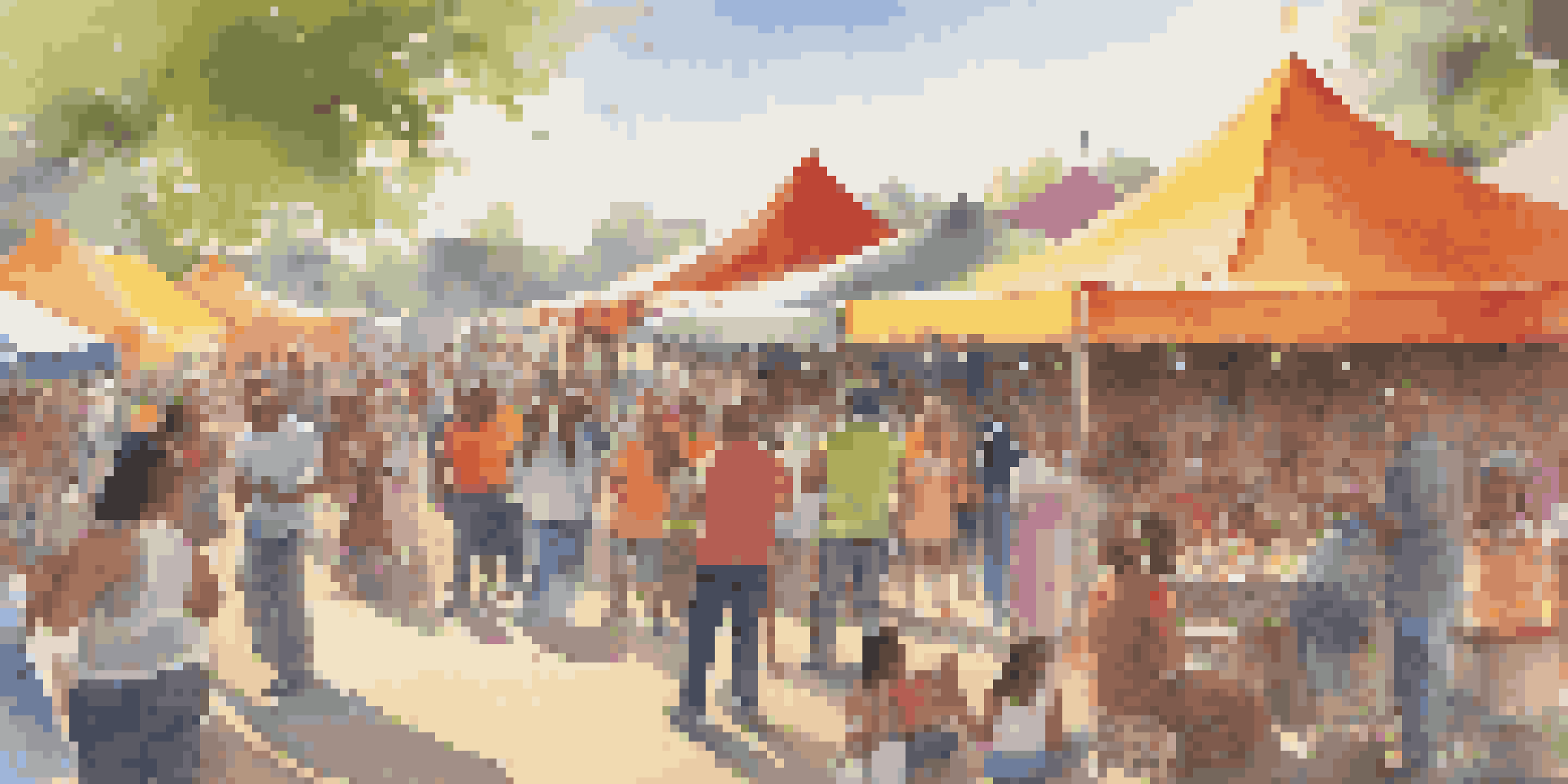 A lively community event with diverse people enjoying activities under colorful tents on a sunny day.