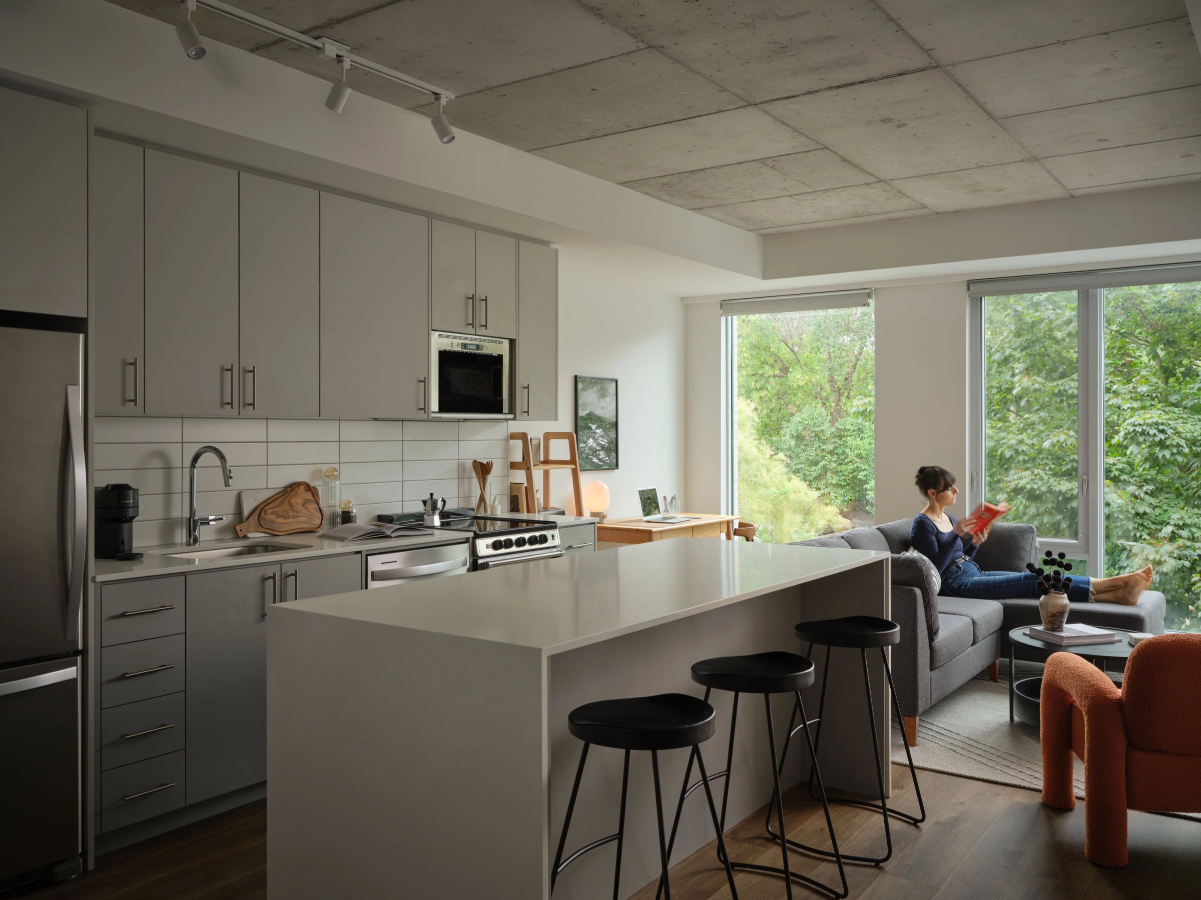 Open kitchen and living area, person reading