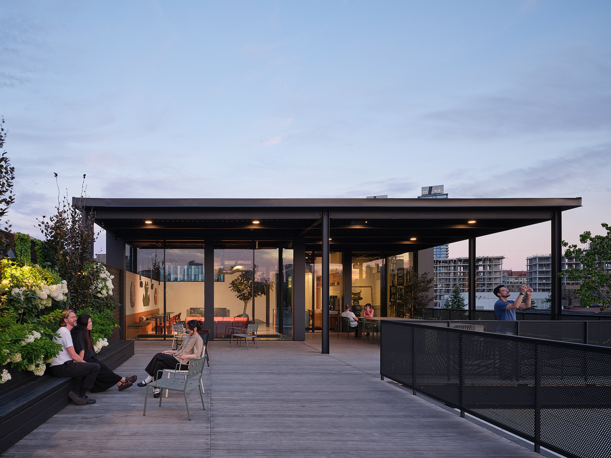 People on a rooftop terrace with a canopy