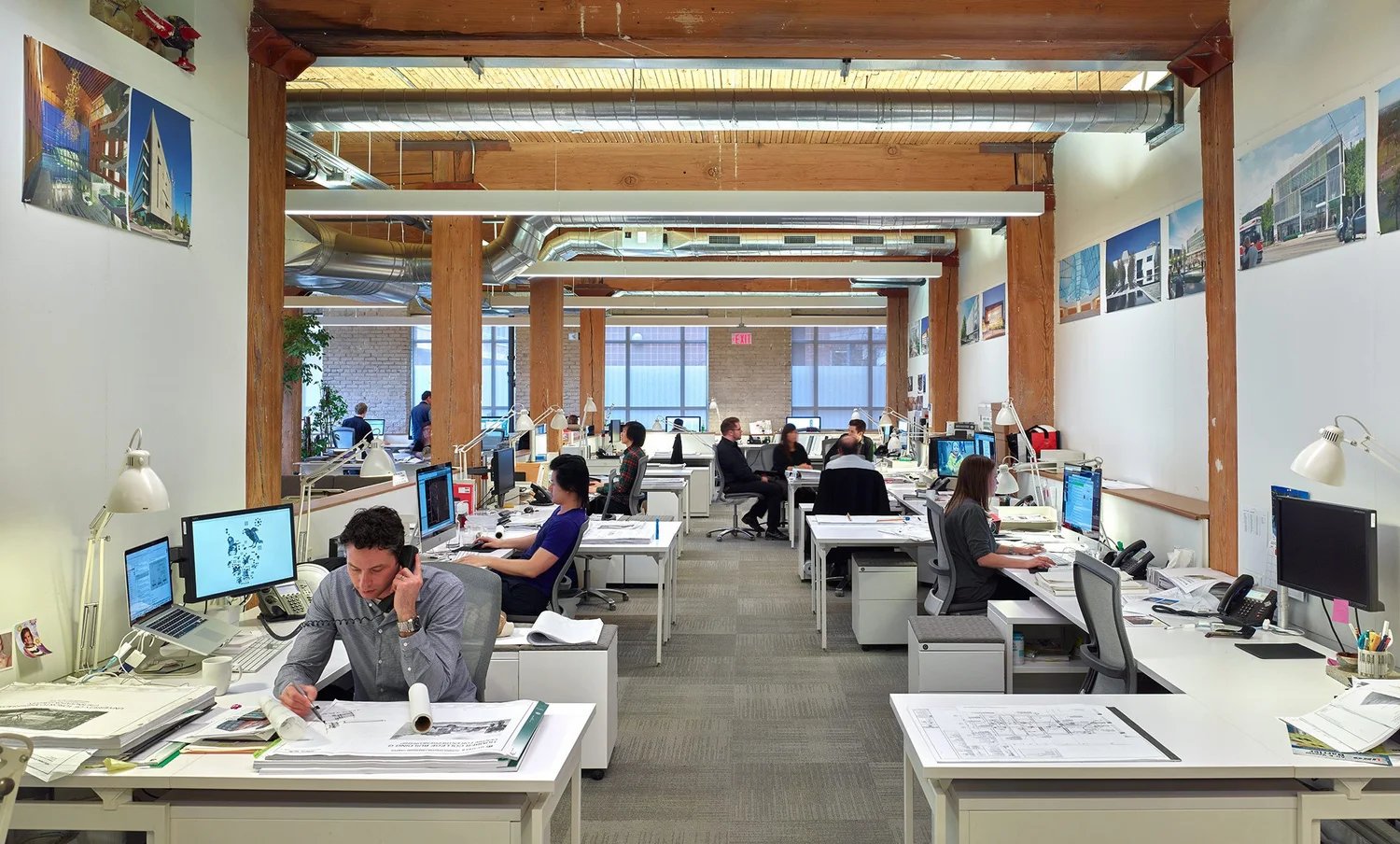Studio workspace with desks under timber beams