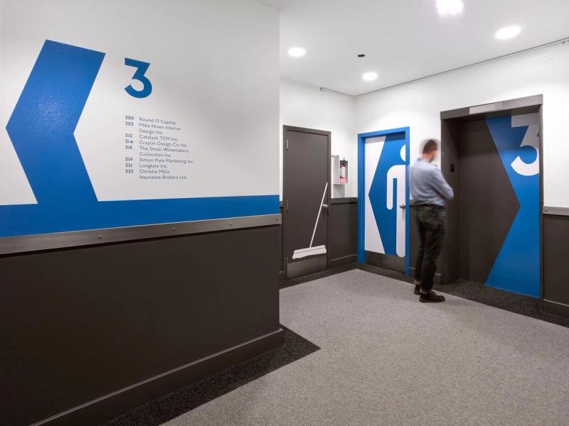 Elevator lobby with blue graphic wall