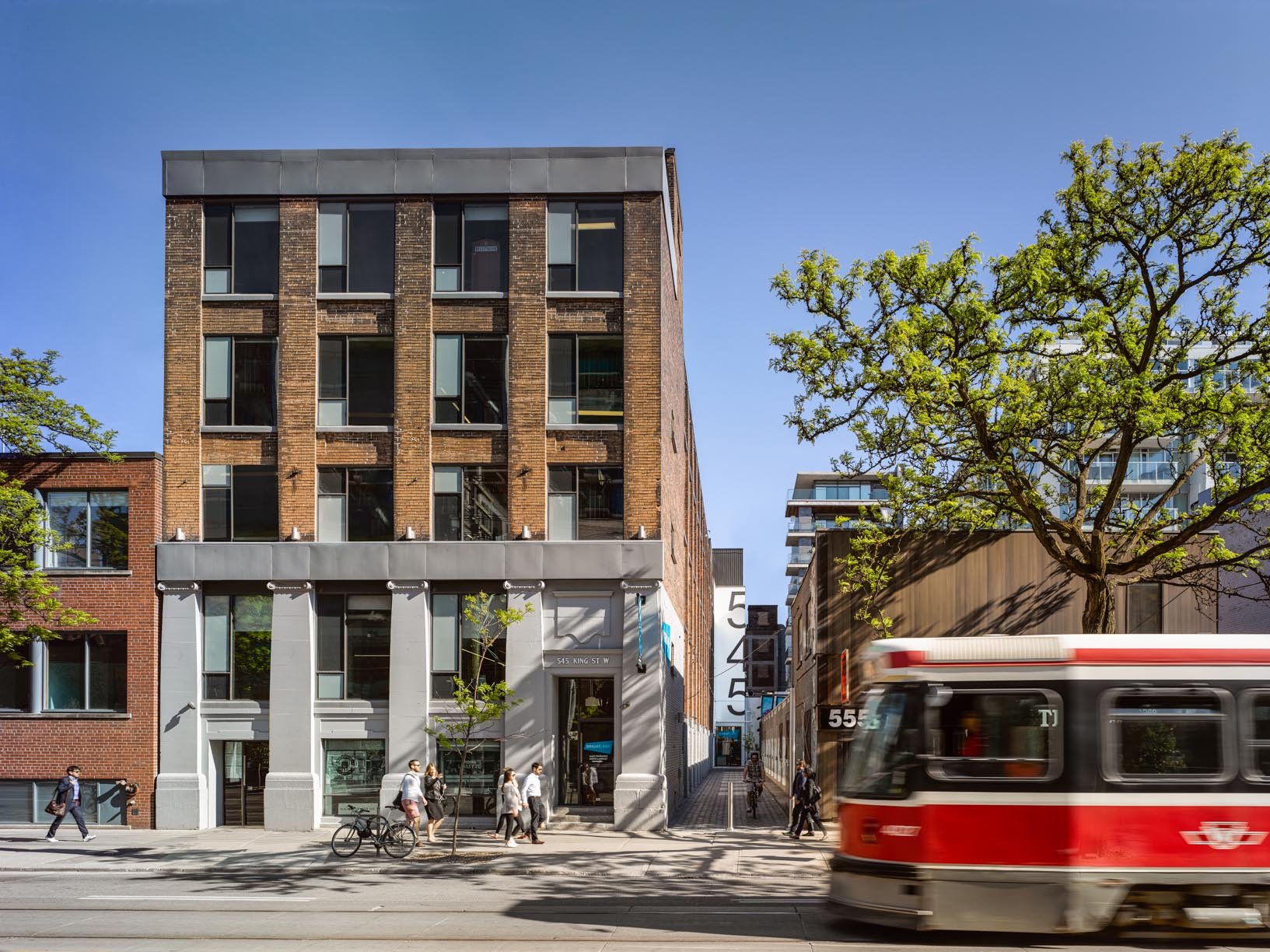 Exterior shot of 545 King West while TTC is driving back