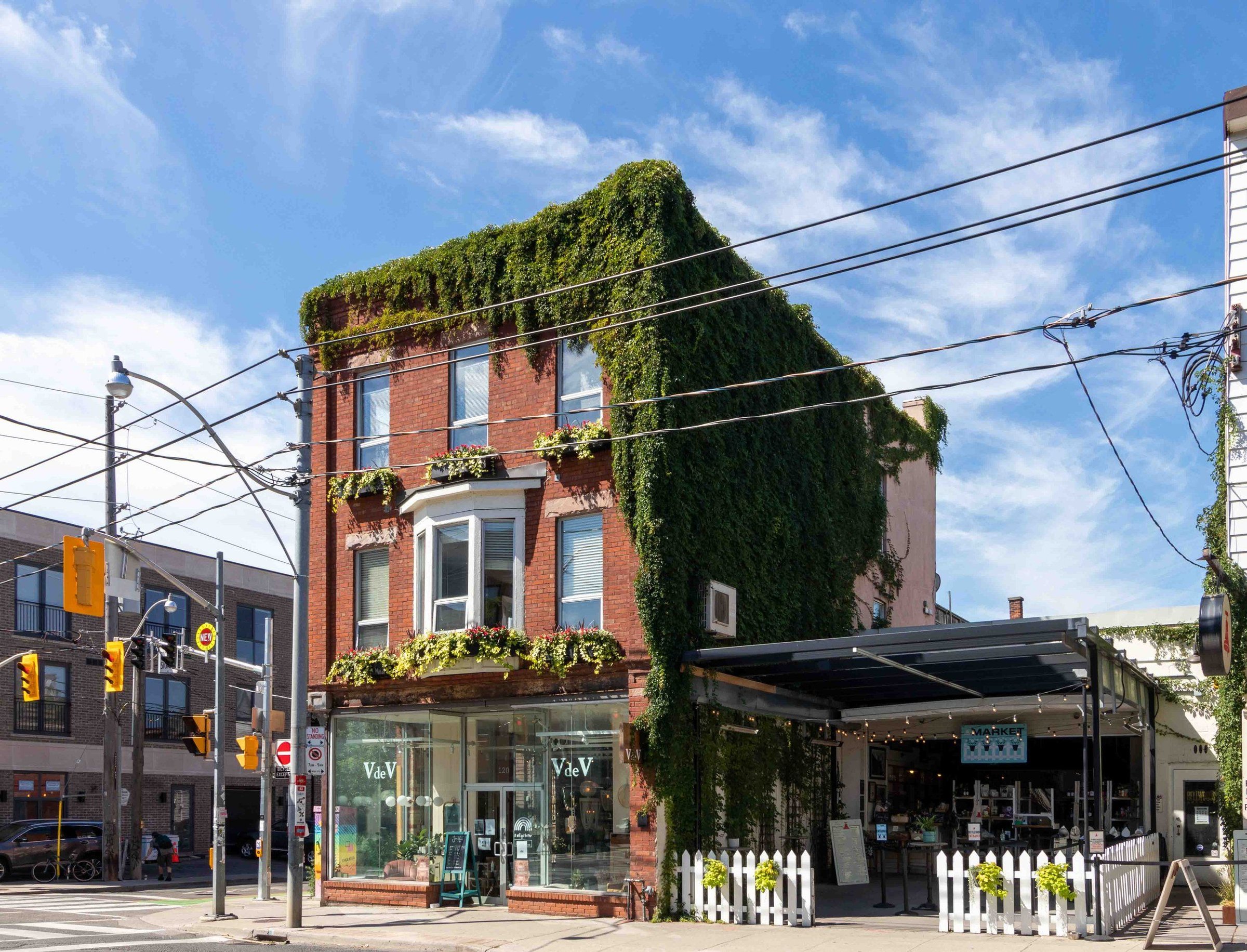 Ivy-covered brick corner shop building