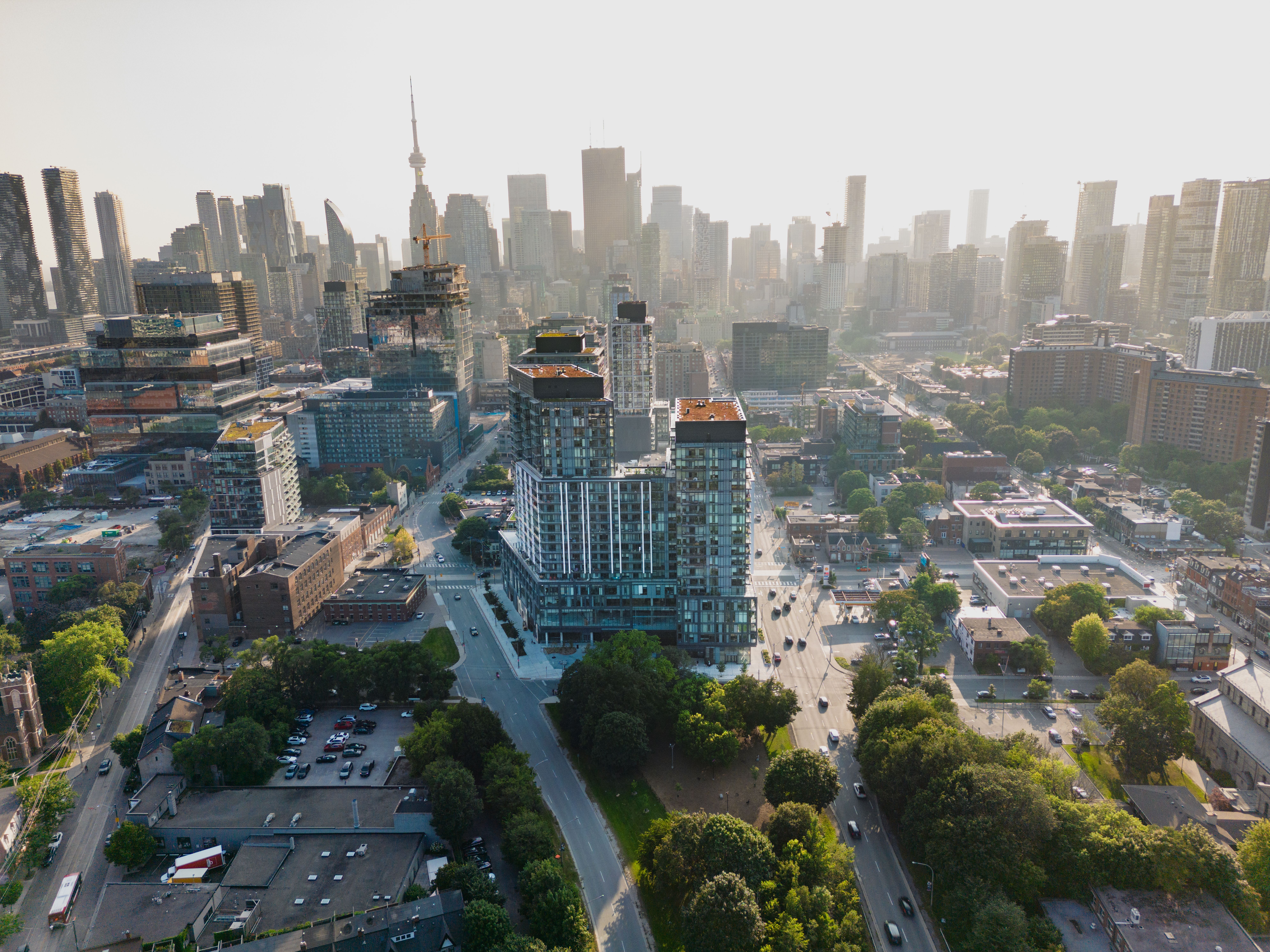 Aerial view of a condo tower and city skyline