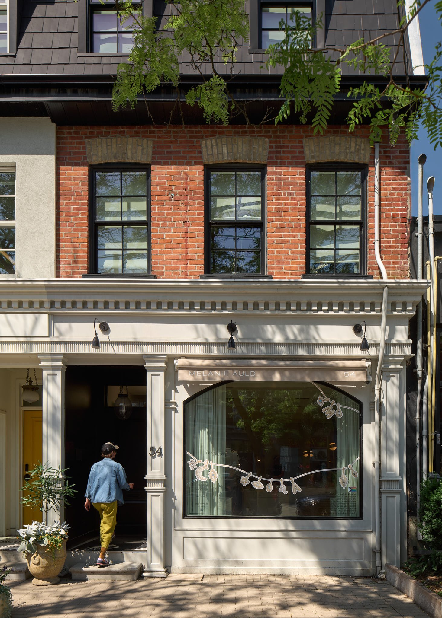 Red brick storefront with white shopfront trim