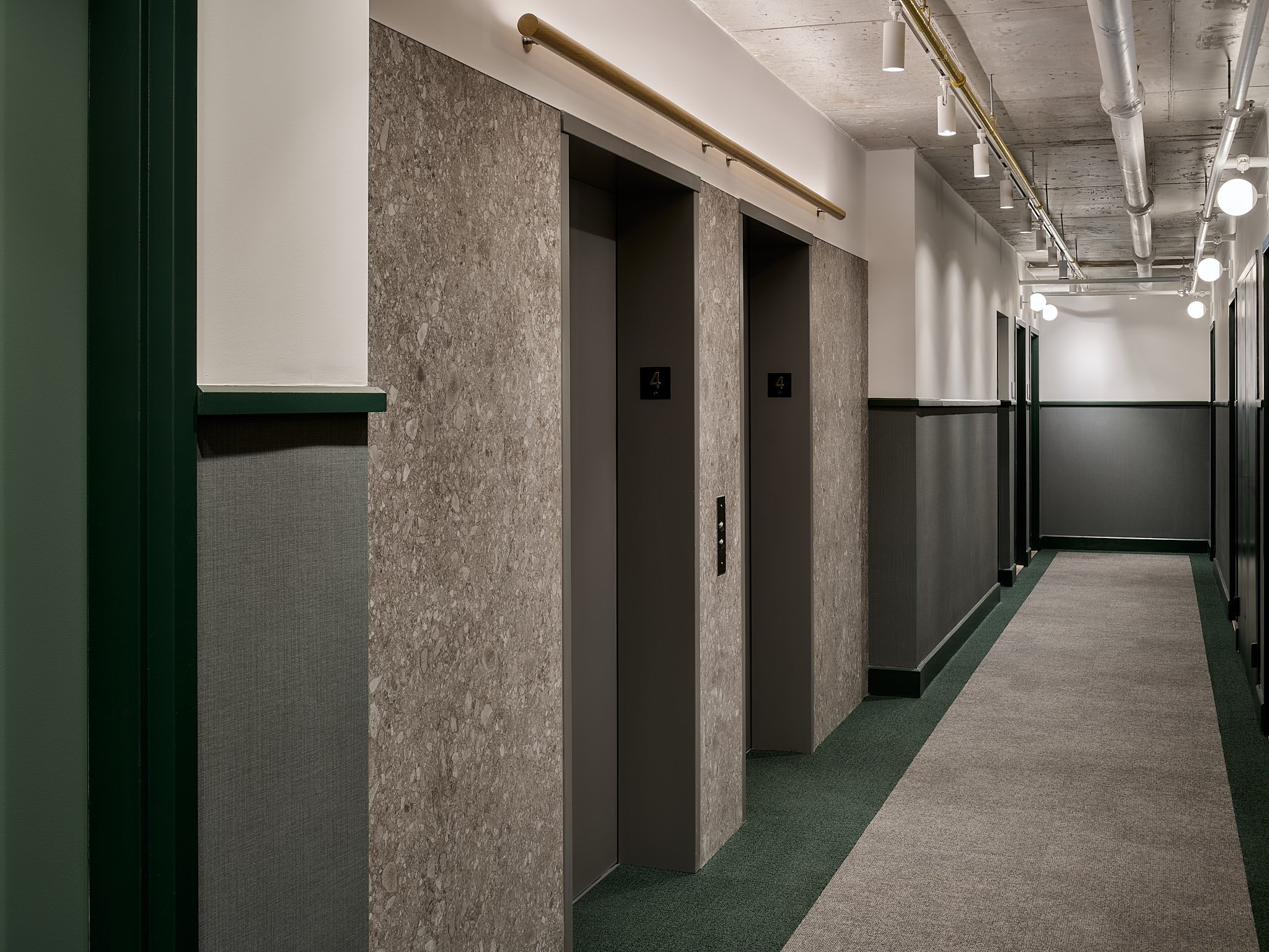 Corridor with stone-clad elevator doors