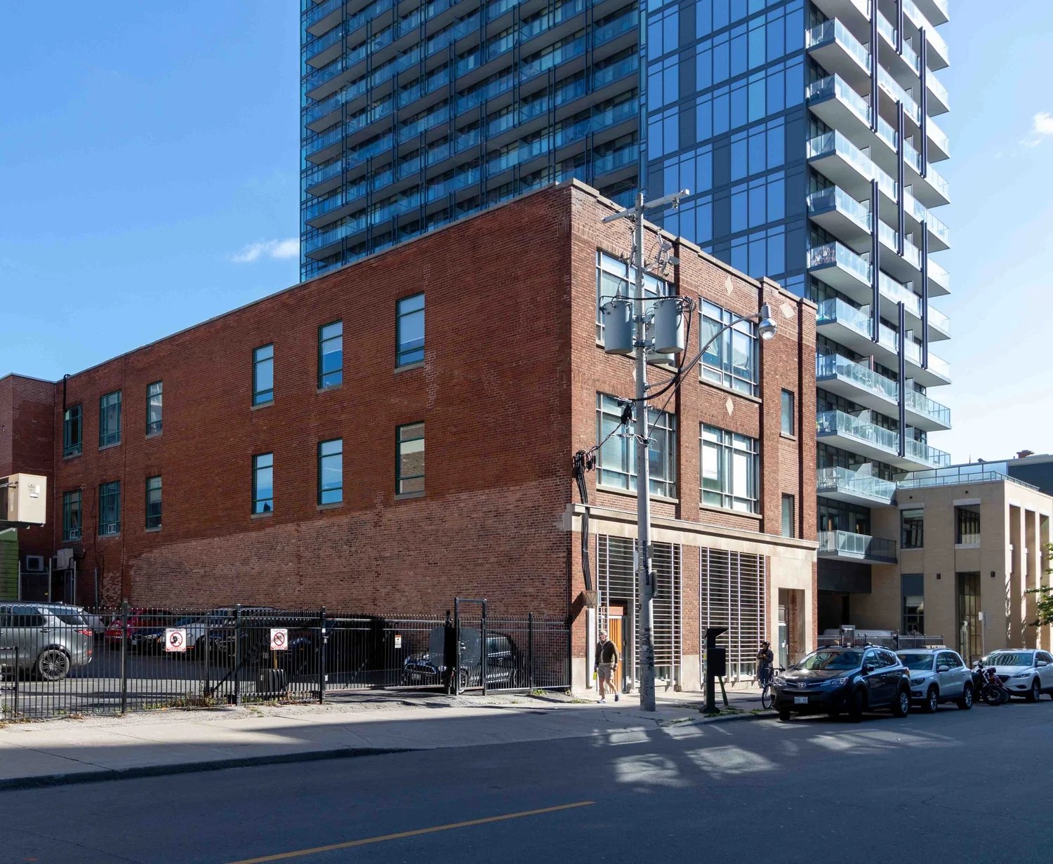 Low brick building beside a glass tower