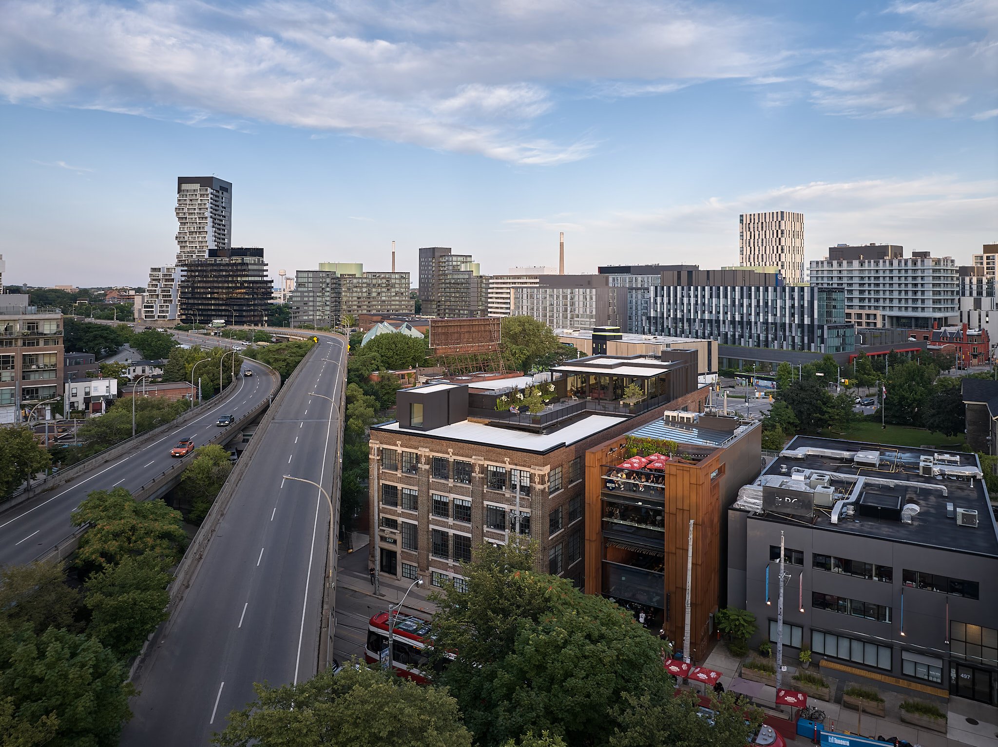 Aerial of a brick office block beside a highway