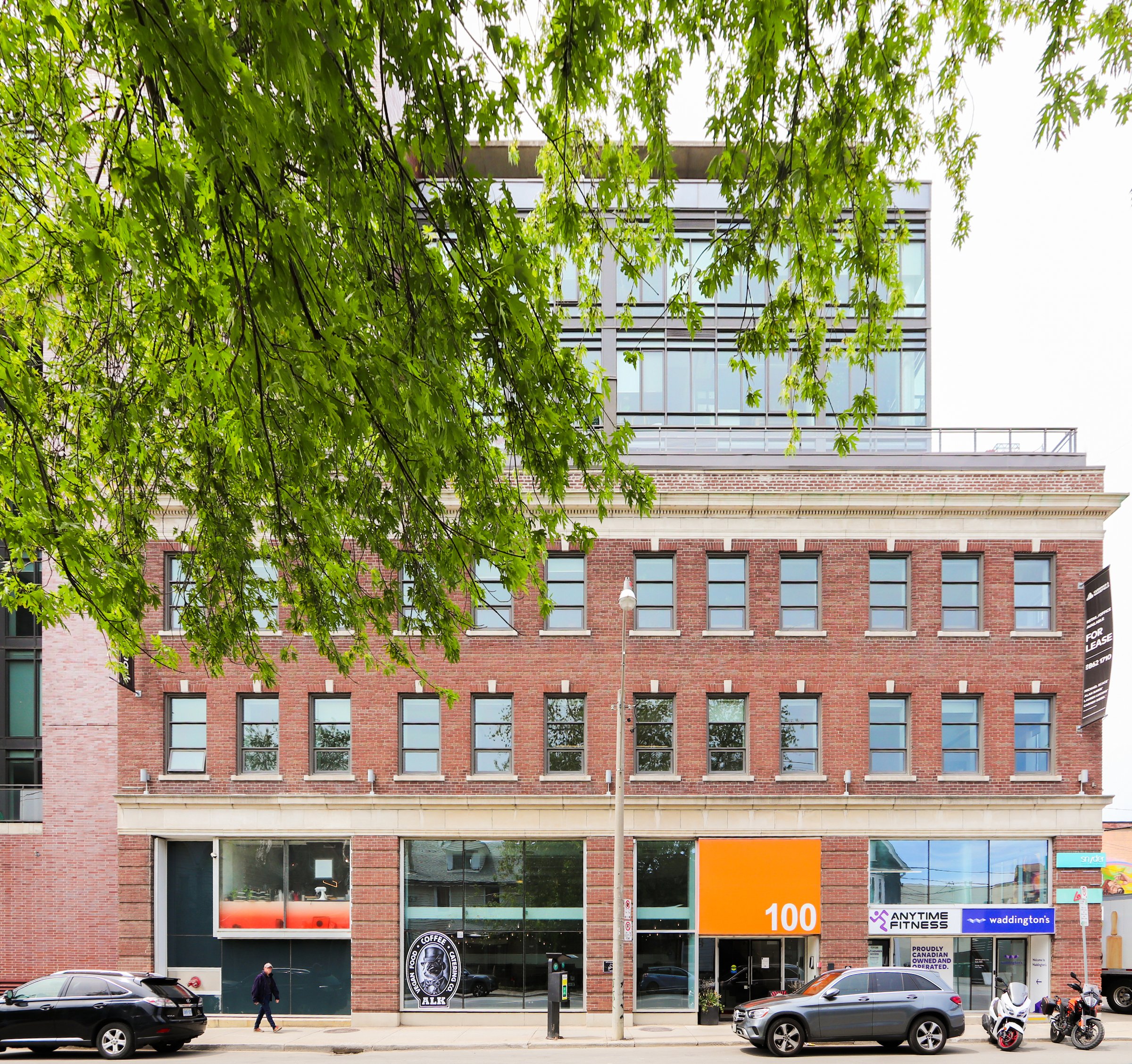 Red brick building with glass floors above