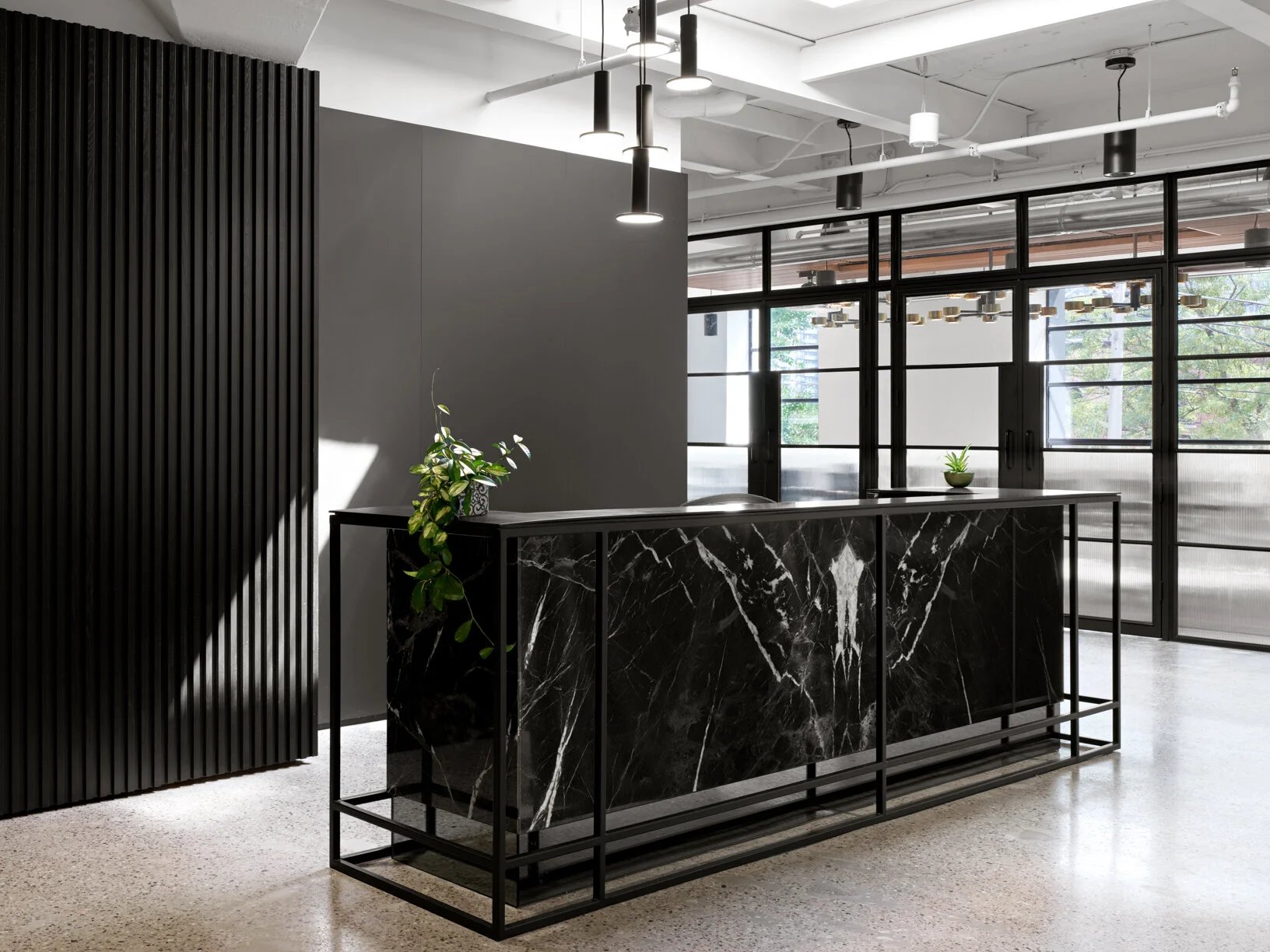 Black marble reception desk in an office lobby