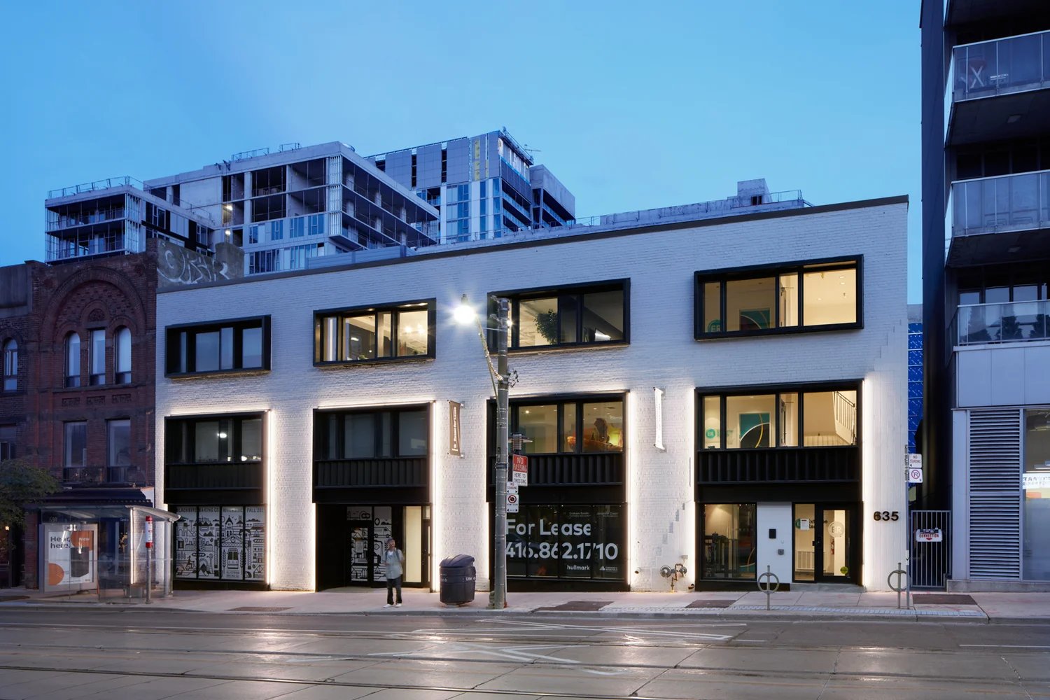 White two-storey commercial building at dusk